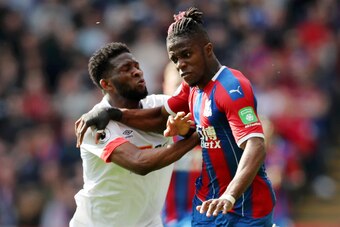 LONDON, ENGLAND - MAY 12: Wilfried Zaha of Crystal Palace battles for possession with Jefferson Lerma of AFC Bournemouth during the Premier League match between Crystal Palace and AFC Bournemouth at Selhurst Park on May 12, 2019 in London, United Kingdom.