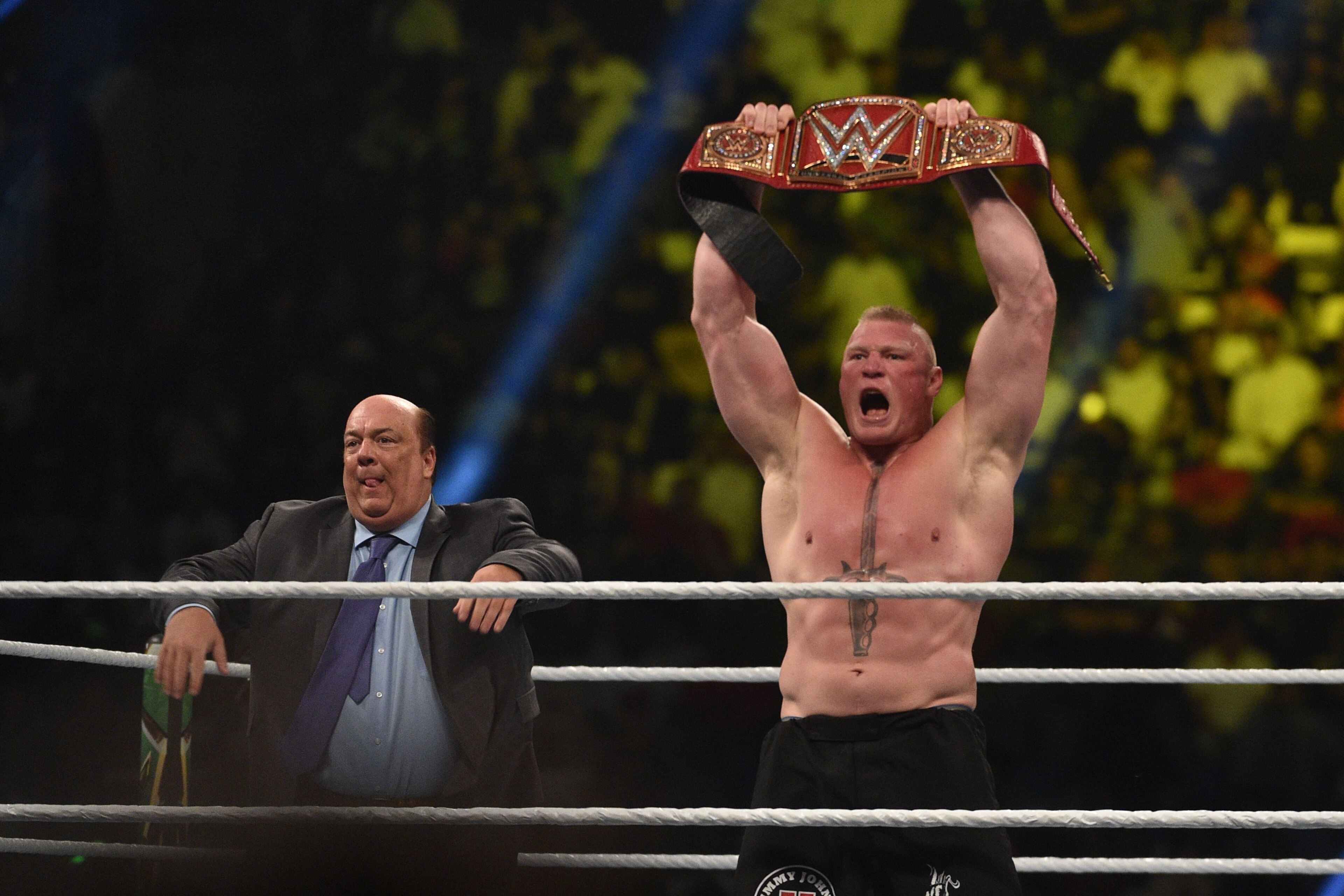 Brock Lesnar celebrates, with his manager Paul Heyman, after winning the WWE Universal Championship match as part of as part of the World Wrestling Entertainment (WWE) Crown Jewel pay-per-view at the King Saud University Stadium in Riyadh on November 2, 2