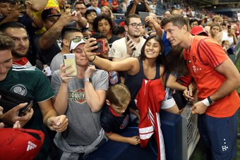 KANSAS CITY, MISSOURI - JULY 23:  Robert Lewandowski #9 of Bayern Munich signs autographs for fans after the International Champions Cup match against AC Milan at Children's Mercy Park on July 23, 2019 in Kansas City, Kansas. (Photo by Jamie Squire/Intern