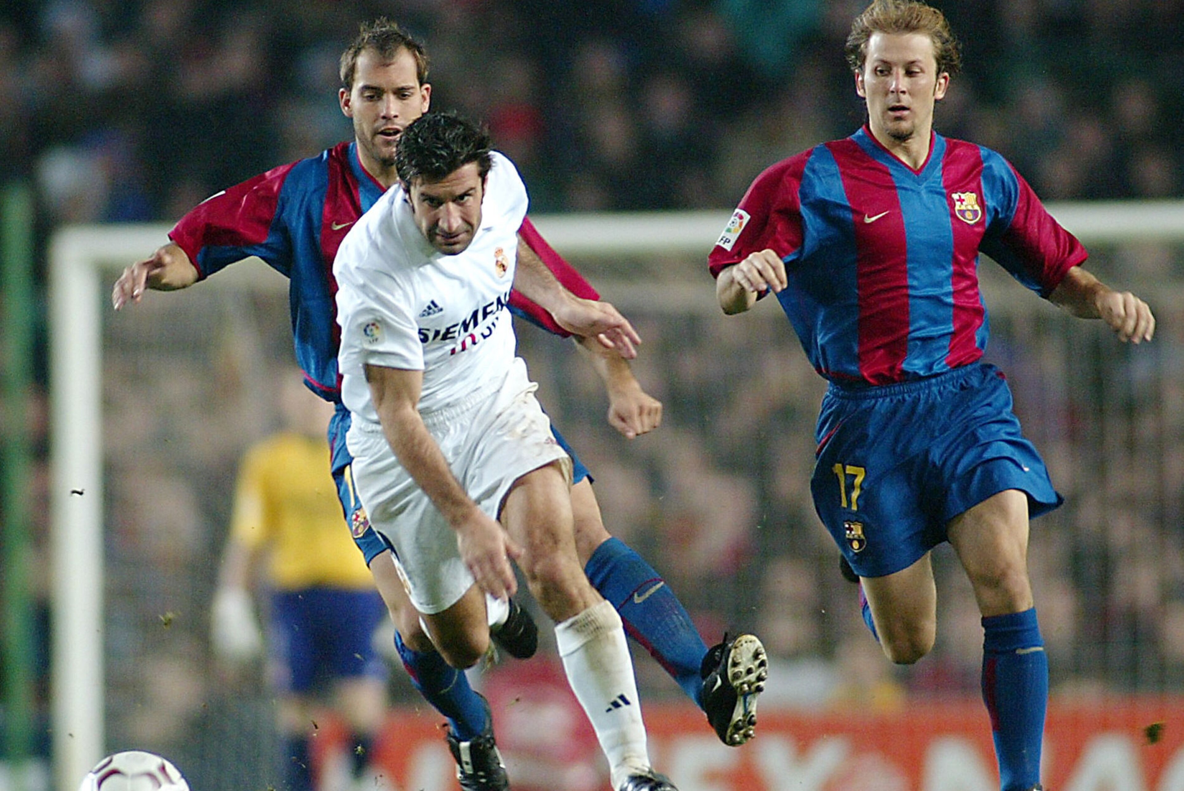BARCELONA, SPAIN:  Portuguese Real Madrid's Luis Figo (C) vies betwen Bacelona's players Gabri (L) and Gaizka Mendieta (R) during their Spanish League match, Barcelona vs. Real Madrid, in Camp Nou Stadium in Barcelona, 23 November 2002.  The match ended d
