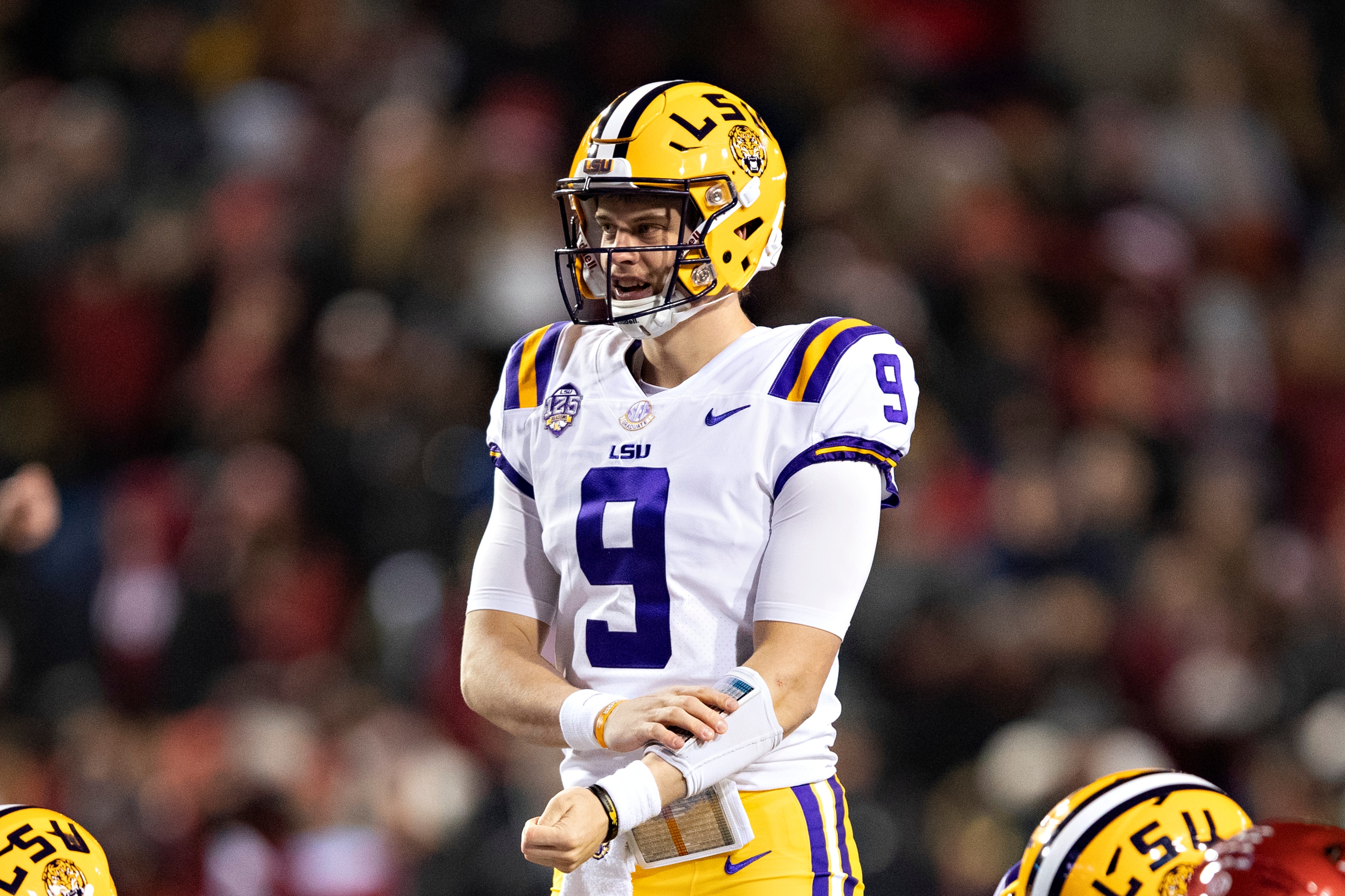 FAYETTEVILLE, AR - NOVEMBER 10:  Joe Burrow #9 of the LSU Tigers at the line of scrimmage during a game against the Arkansas Razorbacks at Razorback Stadium on November 10, 2018 in Fayetteville, Arkansas.  The Tigers defeated the Razorbacks 24-17.  (Photo