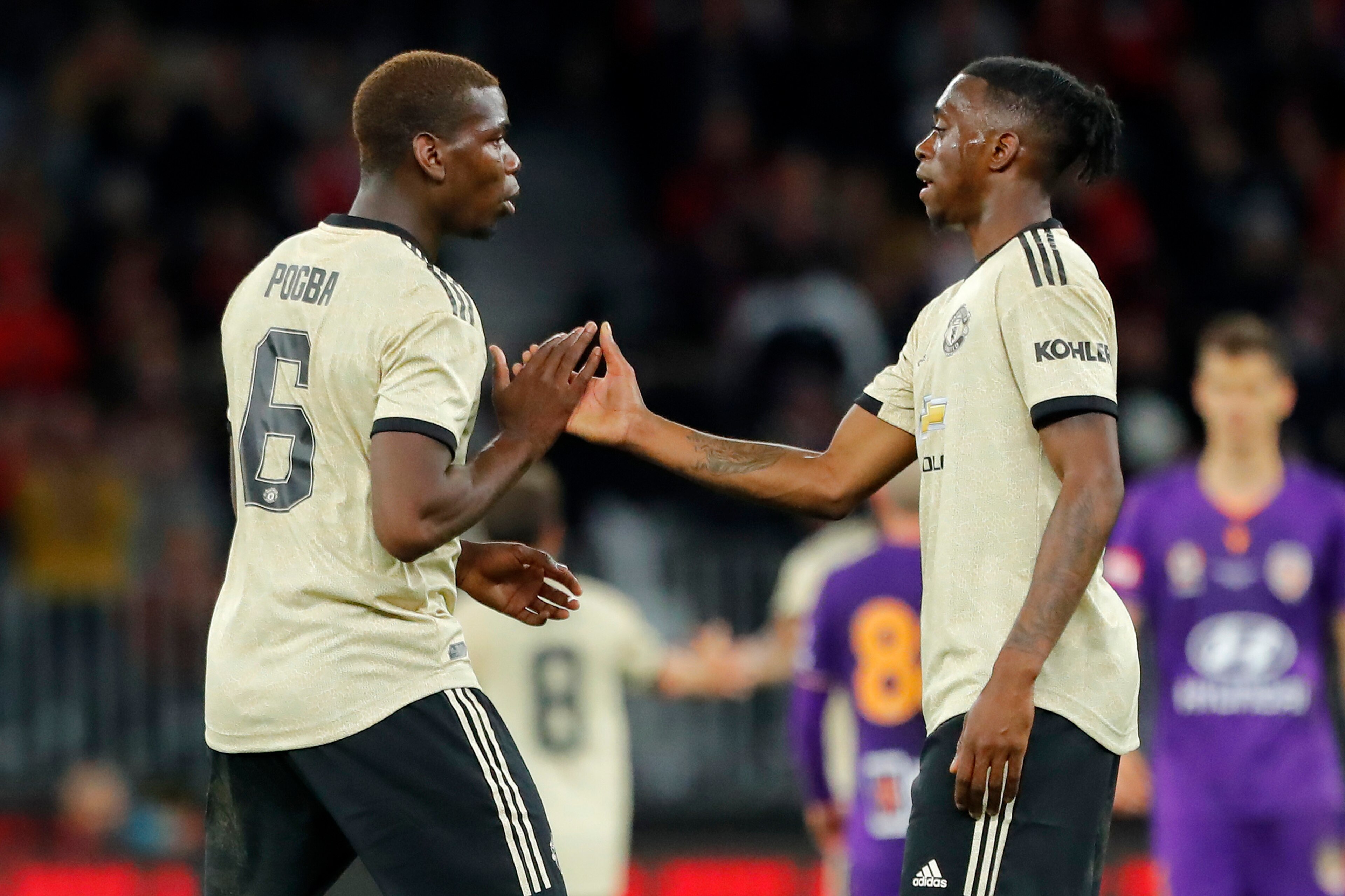 PERTH, AUSTRALIA - JULY 13: Paul Pogba of Manchester United and Aaron Wan-Bissaka of Manchester United shake hands after their win between the Perth Glory and Manchester United at Optus Stadium on July 13, 2019 in Perth, Australia. (Photo by James Worsfol