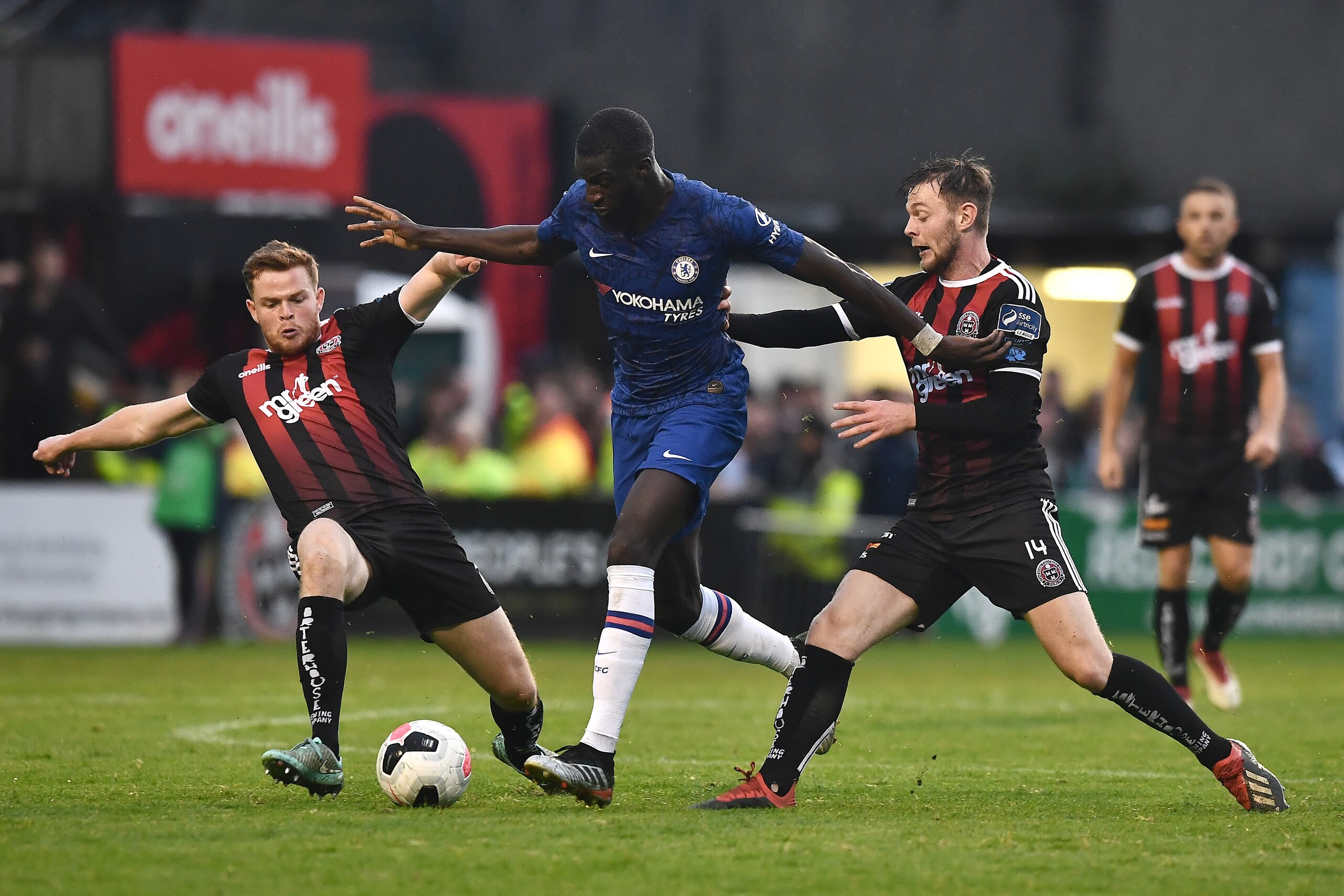 DUBLIN, IRELAND - JULY 10: Tiemoue Bakayoko of Chelsea is challenged by Scott Allardice of Bohrmians (L) and Conor Levingston of Bohemians (R) during the Pre-Season Friendly match between Bohemians FC and Chelsea FC at Dalymount Park on July 10, 2019 in D DUBLIN, IRELAND - JULY 10: Tiemoue Bakayoko of Chelsea is challenged by Scott Allardice of Bohrmians (L) and Conor Levingston of Bohemians (R) during the Pre-Season Friendly match between Bohemians FC and Chelsea FC at Dalymount Park on July 10, 2019 in D