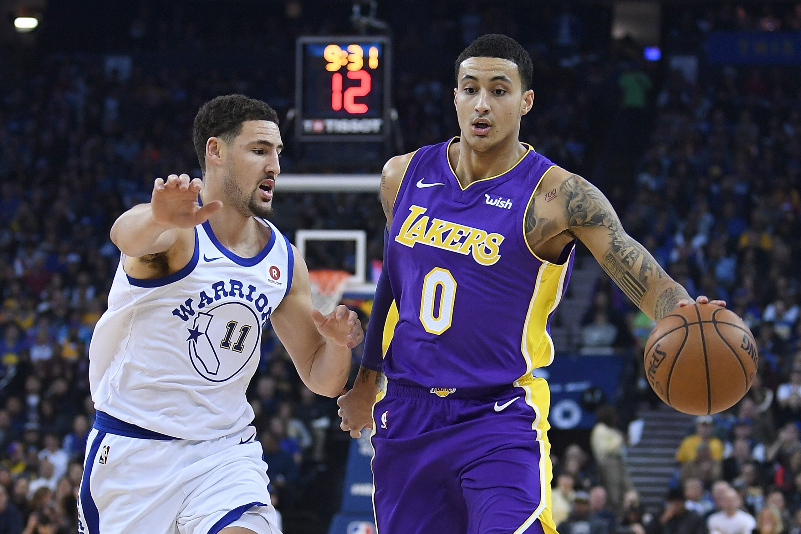 OAKLAND, CA - DECEMBER 22:  Kyle Kuzma #0 of the Los Angeles Lakers dribbles the ball while guarded by Klay Thompson #11 of the Golden State Warriors during an NBA basketball game at ORACLE Arena on December 22, 2017 in Oakland, California. NOTE TO USER: 