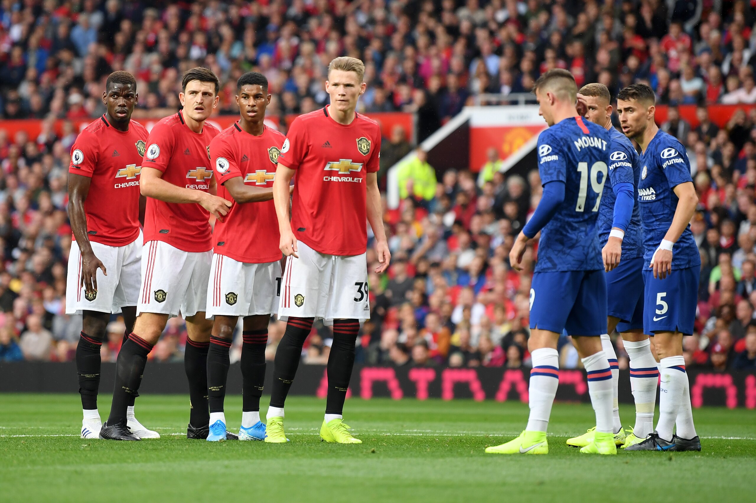 MANCHESTER, ENGLAND - AUGUST 11: Harry Maguire of Manchester United and teammates prepare to compete for a corner during the Premier League match between Manchester United and Chelsea FC at Old Trafford on August 11, 2019 in Manchester, United Kingdom. (P