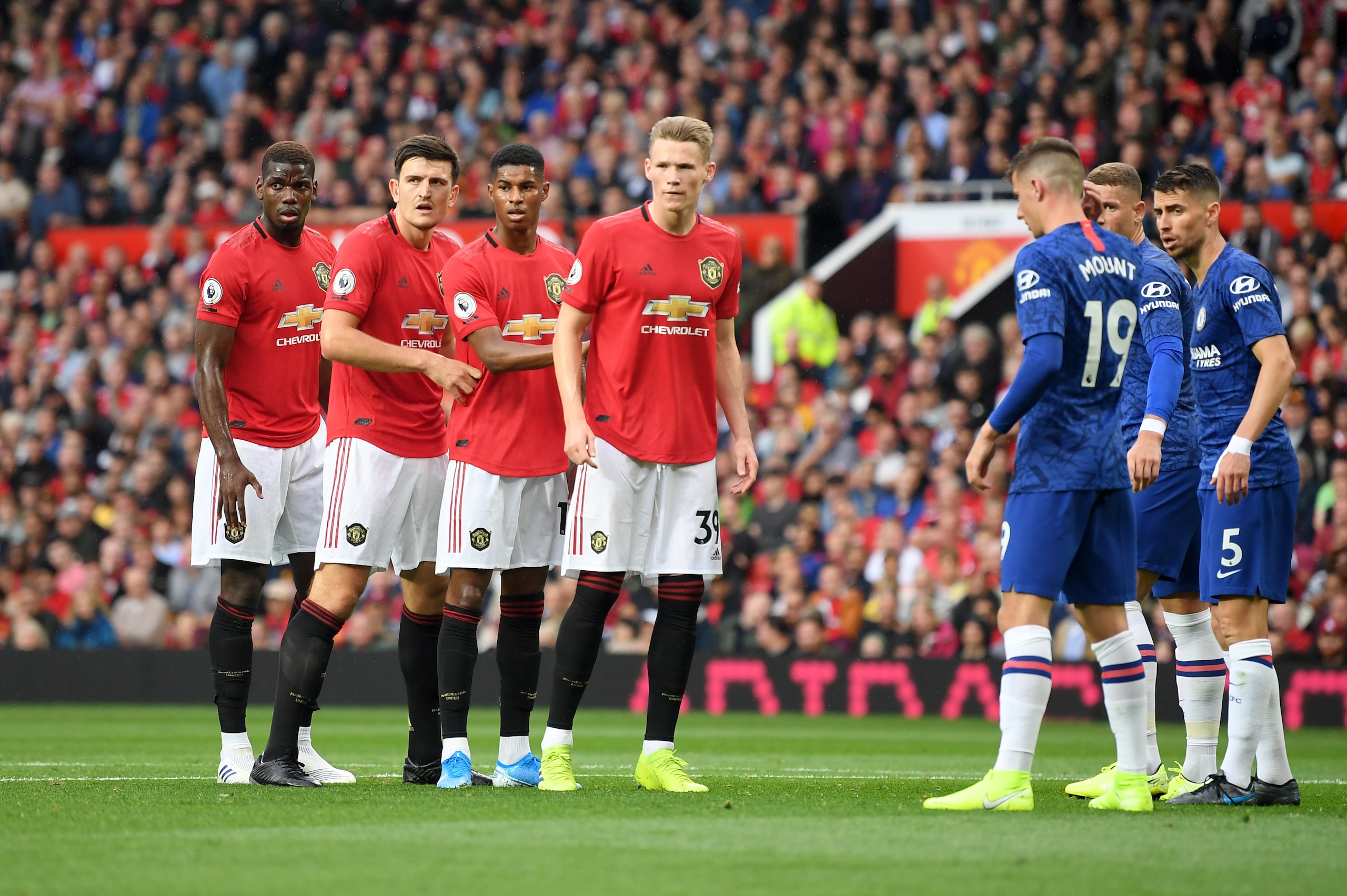 MANCHESTER, ENGLAND - AUGUST 11: Harry Maguire of Manchester United and teammates prepare to compete for a corner during the Premier League match between Manchester United and Chelsea FC at Old Trafford on August 11, 2019 in Manchester, United Kingdom. (P