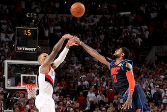 PORTLAND, OR - APRIL 23: Damian Lillard #0 of the Portland Trail Blazers shoots the three point basket over Paul George #13 of the Oklahoma City Thunder to win the game as time expires during Game Five of Round One of the 2019 NBA Playoffs on April 23, 20