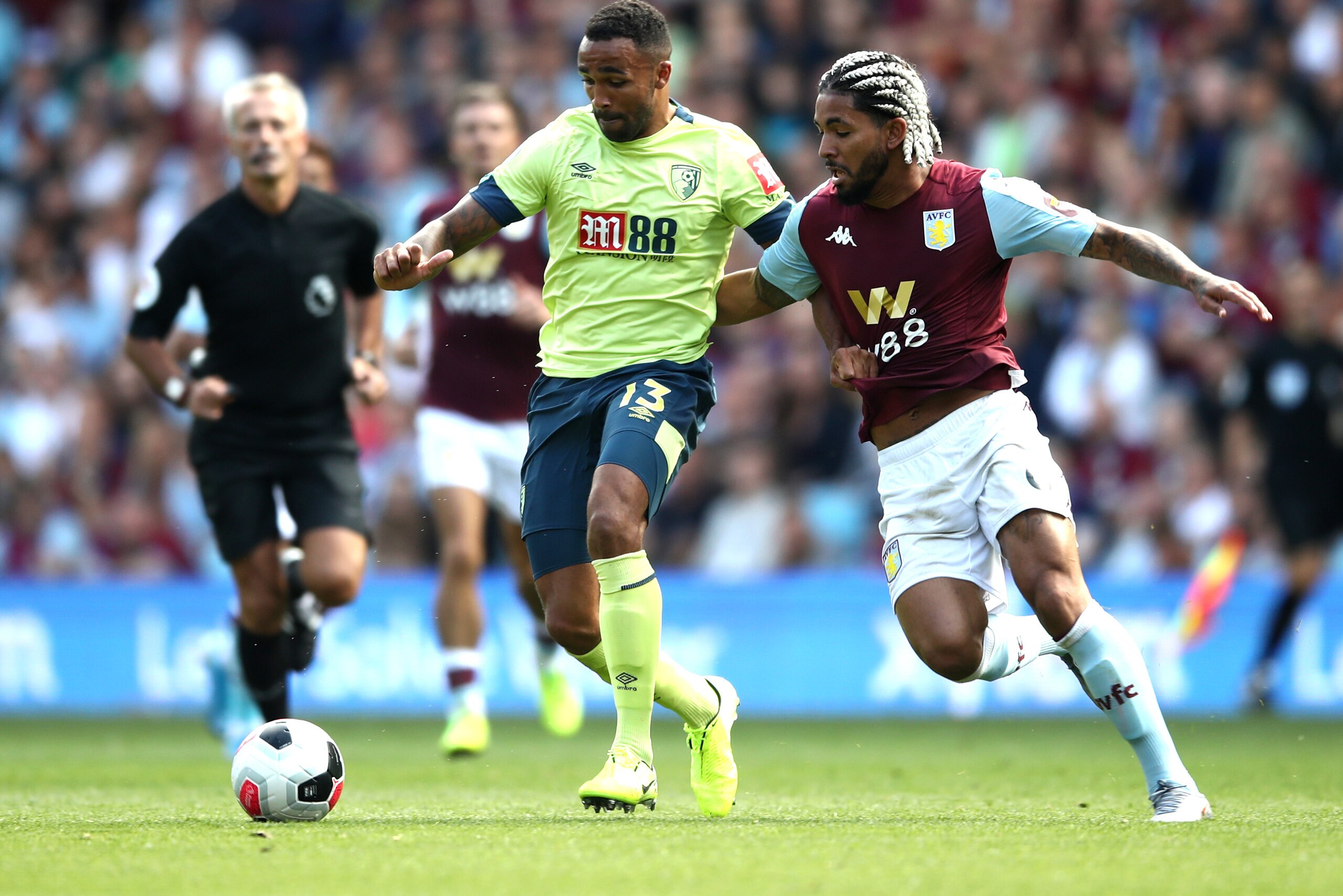 BIRMINGHAM, ENGLAND - AUGUST 17: Callum Wilson of AFC Bournemouth is tackled by Douglas Luiz of Aston Villa  during the Premier League match between Aston Villa and AFC Bournemouth  at Villa Park on August 17, 2019 in Birmingham, United Kingdom. (Photo by