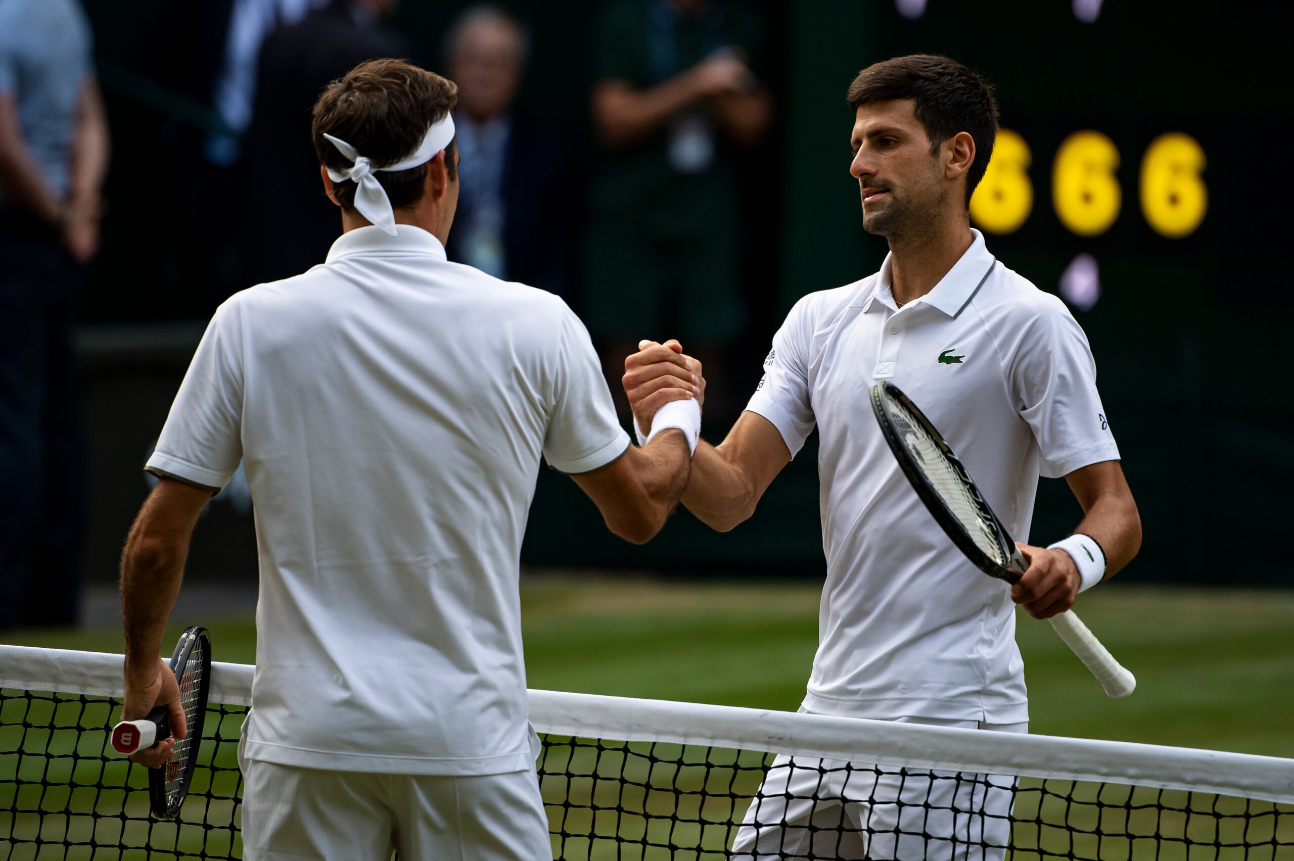 LONDON, ENGLAND - JULY 14: Novak Djokovic of Serbia shakes hands  with Roger Federer of Switzerland after beating him during Day 13 of The Championships - Wimbledon 2019 at All England Lawn Tennis and Croquet Club on July 14, 2019 in London, England. (Pho
