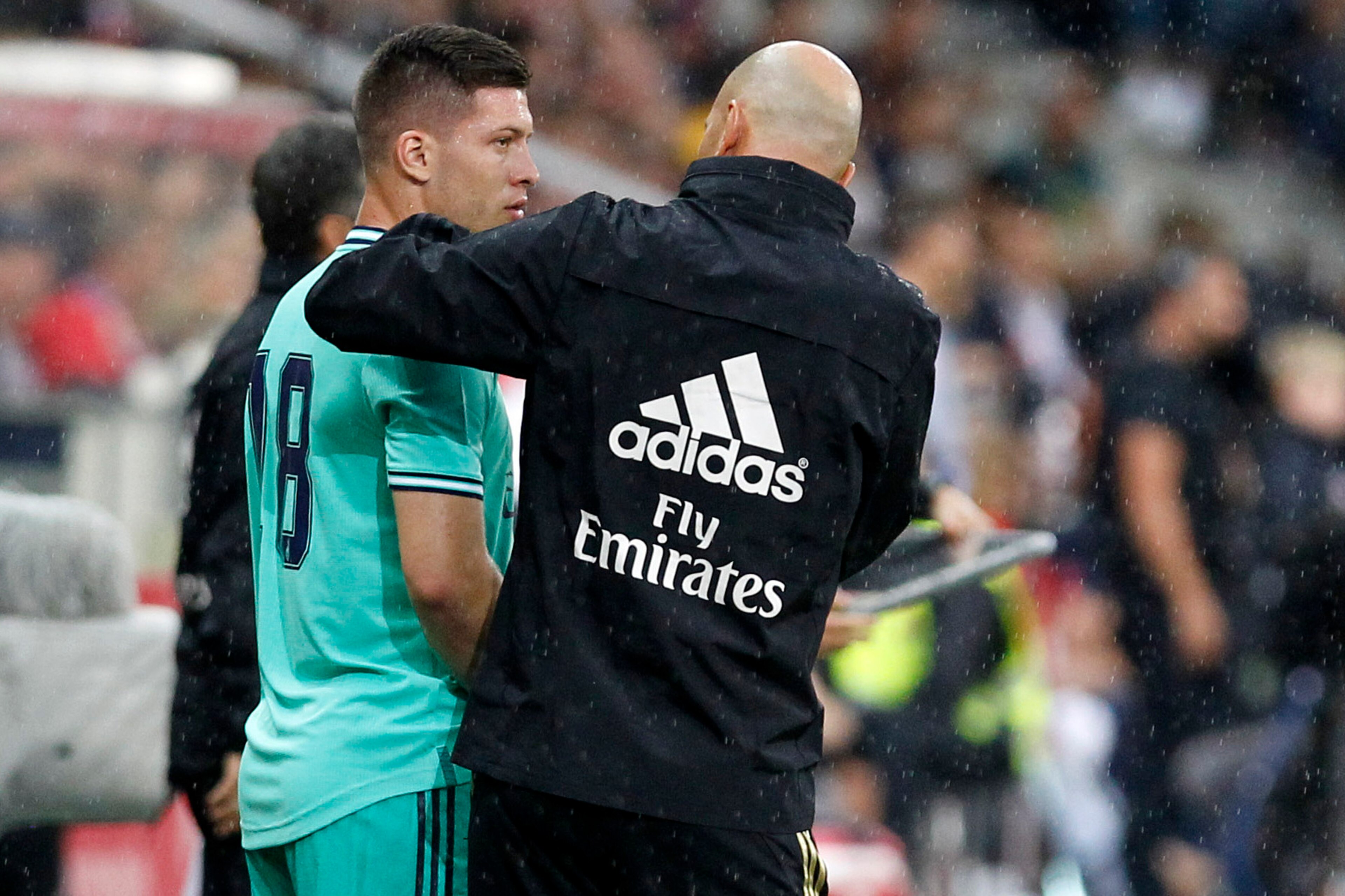 SALZBURG, AUSTRIA - AUGUST 07: Luka Jovic (Real Madrid) speaks with head coach Zinedine Zidane (Real Madrid) during the pre-season friendly match between RB Salzburg and Real Madrid at Red Bull Arena on August 07, 2019 in Salzburg, Austria. (Photo by TF-I