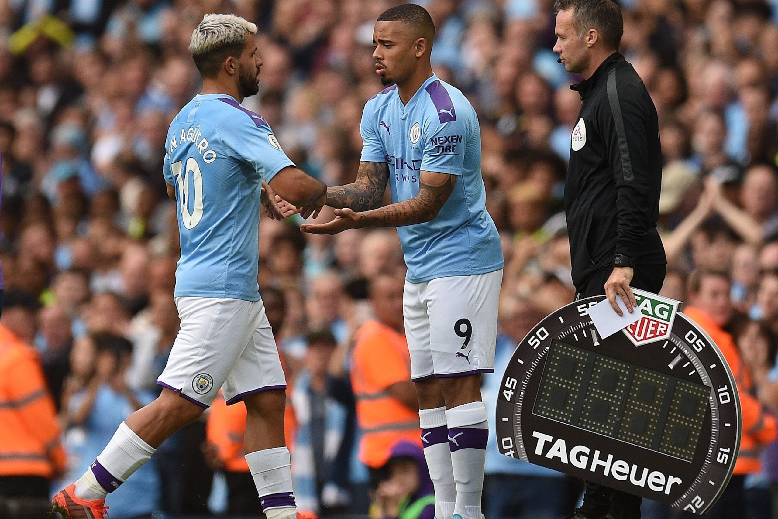 Manchester City's Argentinian striker Sergio Aguero (L) leaves the pitch after being substituted off for Manchester City's Brazilian striker Gabriel Jesus during the English Premier League football match between Manchester City and Tottenham Hotspur at th