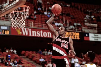 HOUSTON - 1990: Clyde Drexler #22 of the Portland Trail Blazers dunks circa 1990 at the Summitt in Houston, Texas. NOTE TO USER: User expressly acknowledges and agrees that, by downloading and or using this photograph, User is consenting to the terms and 