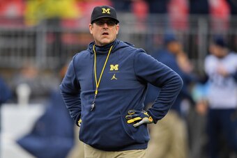 COLUMBUS, OH - NOVEMBER 24:  Head Coach Jim Harbaugh of the Michigan Wolverines watches his team warm up before a game against the Ohio State Buckeyes at Ohio Stadium on November 24, 2018 in Columbus, Ohio. Ohio State defeated Michigan 62-39.  (Photo by J
