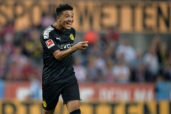 COLOGNE, GERMANY - AUGUST 23: Jadon Sancho of Dortmund celebrates after Dortmunds 3-1 lead scored by teammate Paco Alcacer (not in frame) during the Bundesliga match between 1. FC Koeln and Borussia Dortmund at RheinEnergieStadion on August 23, 2019 in Co