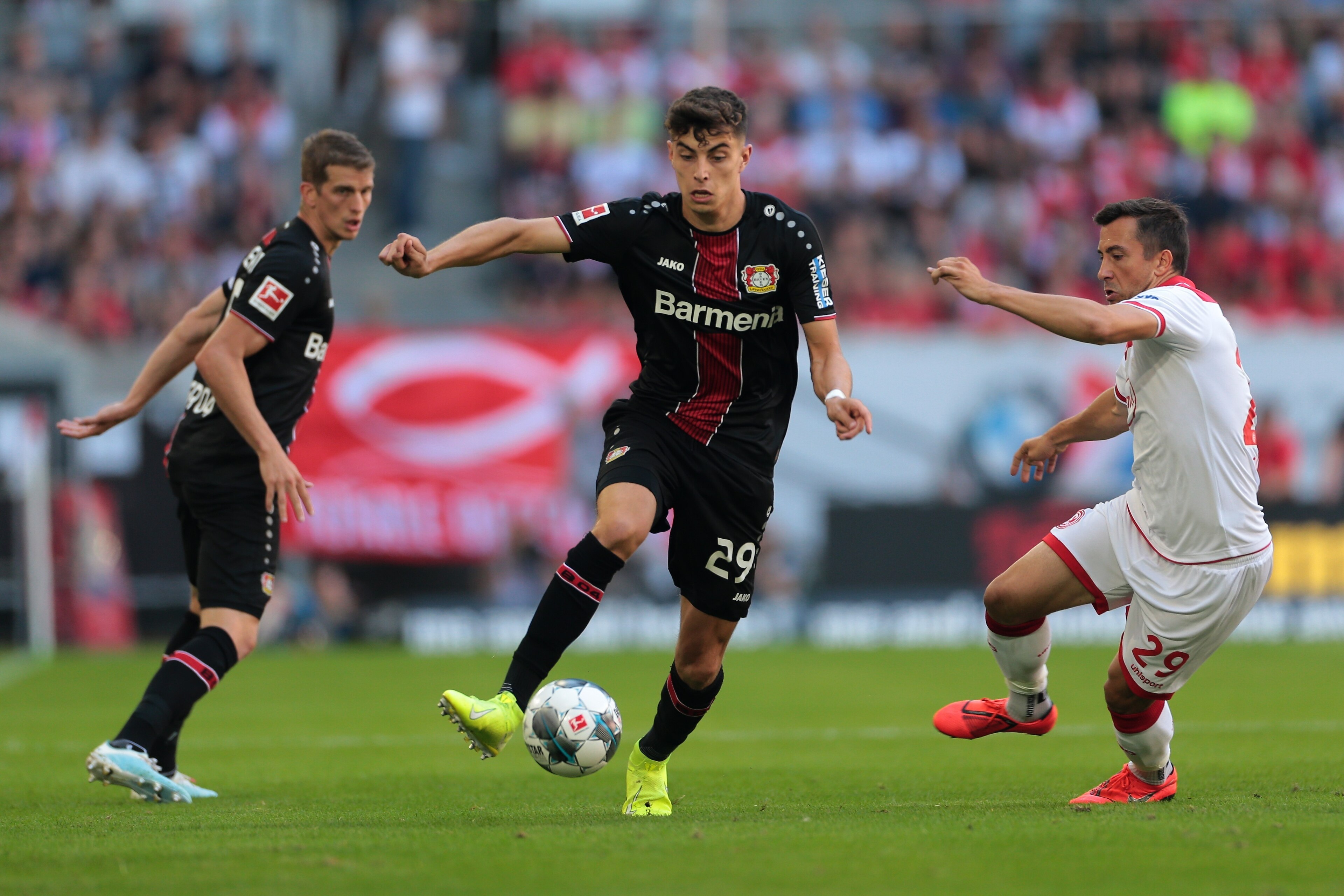 DUESSELDORF, GERMANY - AUGUST 24 : Lars Bender of Bayer 04 Leverkusen, Kai Havertz of Bayer 04 Leverkusen and Markus Suttner of Fortuna Duesseldorf battle for the ball during the Bundesliga match between Fortuna Duesseldorf and Bayer 04 Leverkusen at Merk DUESSELDORF, GERMANY - AUGUST 24 : Lars Bender of Bayer 04 Leverkusen, Kai Havertz of Bayer 04 Leverkusen and Markus Suttner of Fortuna Duesseldorf battle for the ball during the Bundesliga match between Fortuna Duesseldorf and Bayer 04 Leverkusen at Merk