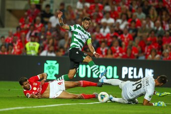 FARO, PORTUGAL - AUGUST 04: Ruben Dias of SL Benfica (L) and Odysseas Vlachodimos of SL Benfica (R) stops Bruno Fernandes of Sporting CP (C) kick during the match between SL Benfica and Sporting CP for Portuguese SuperCup at Estadio Algarve on August 4, 2