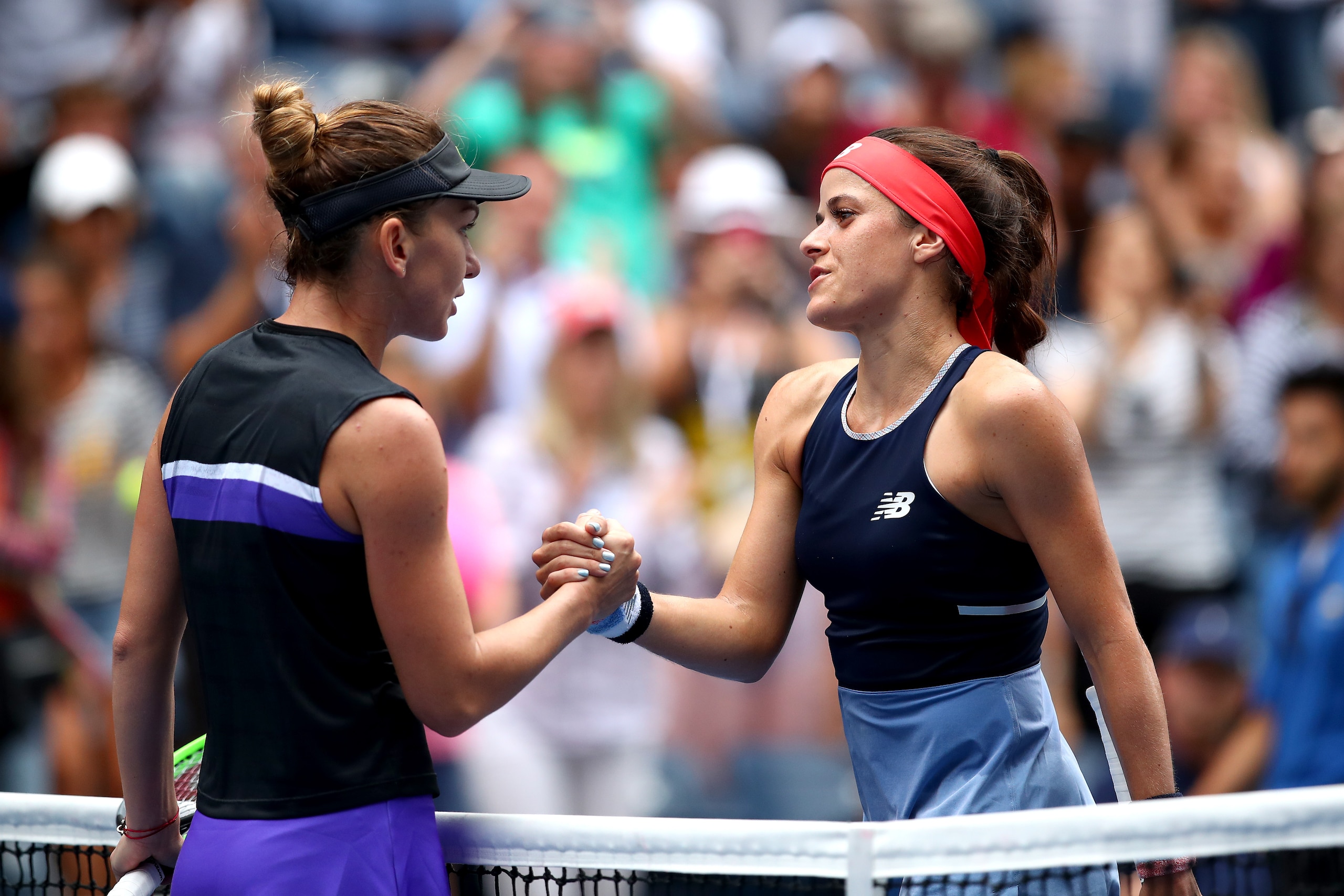 NEW YORK, NEW YORK - AUGUST 27: Simona Halep of Romania and  Nicole Gibbs of the United States shake hands following their Women's Singles first round match on day two of the 2019 US Open at the USTA Billie Jean King National Tennis Center on August 27, 2
