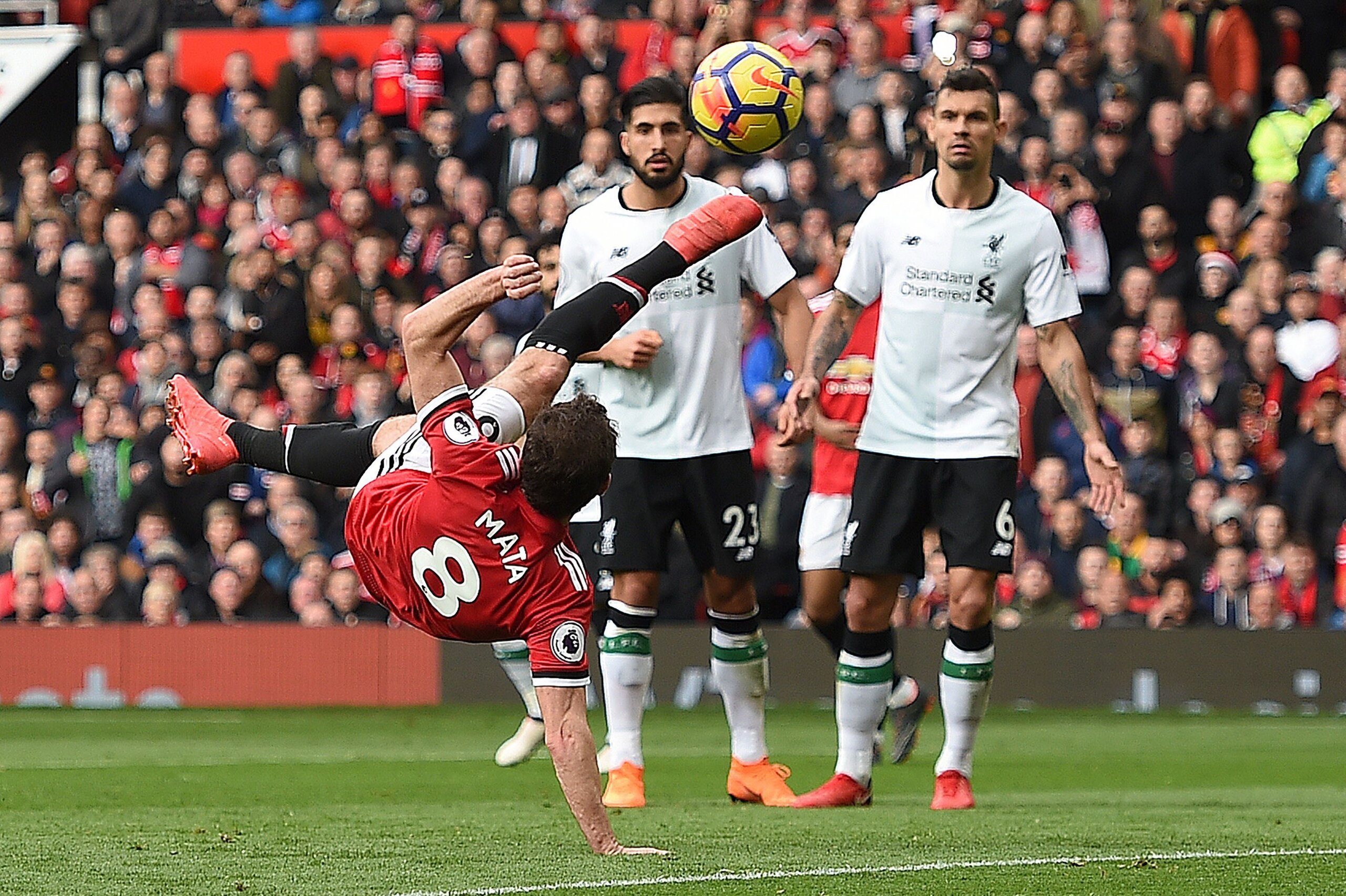 TOPSHOT - Manchester United's Spanish midfielder Juan Mata (L) attempts an overhead kick that goes wide Liverpool's German midfielder Emre Can (C) and Liverpool's Croatian defender Dejan Lovren (R) look on during the English Premier League football match TOPSHOT - Manchester United's Spanish midfielder Juan Mata (L) attempts an overhead kick that goes wide Liverpool's German midfielder Emre Can (C) and Liverpool's Croatian defender Dejan Lovren (R) look on during the English Premier League football match