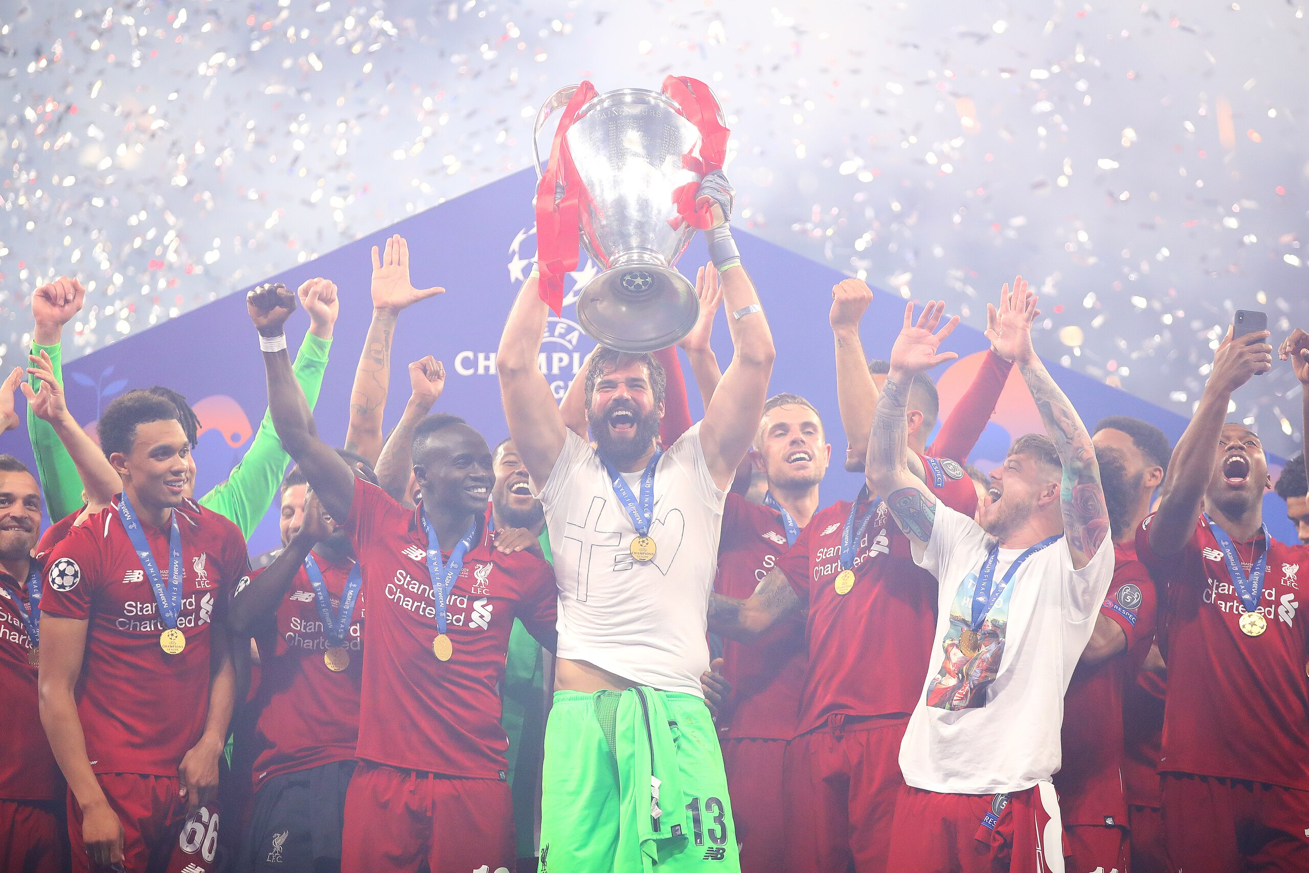 MADRID, SPAIN - JUNE 01: Alisson of Liverpool lifts the trophy following the UEFA Champions League Final between Tottenham Hotspur and Liverpool at Estadio Wanda Metropolitano on June 01, 2019 in Madrid, Spain. (Photo by Chris Brunskill/Fantasista/Getty I MADRID, SPAIN - JUNE 01: Alisson of Liverpool lifts the trophy following the UEFA Champions League Final between Tottenham Hotspur and Liverpool at Estadio Wanda Metropolitano on June 01, 2019 in Madrid, Spain. (Photo by Chris Brunskill/Fantasista/Getty I