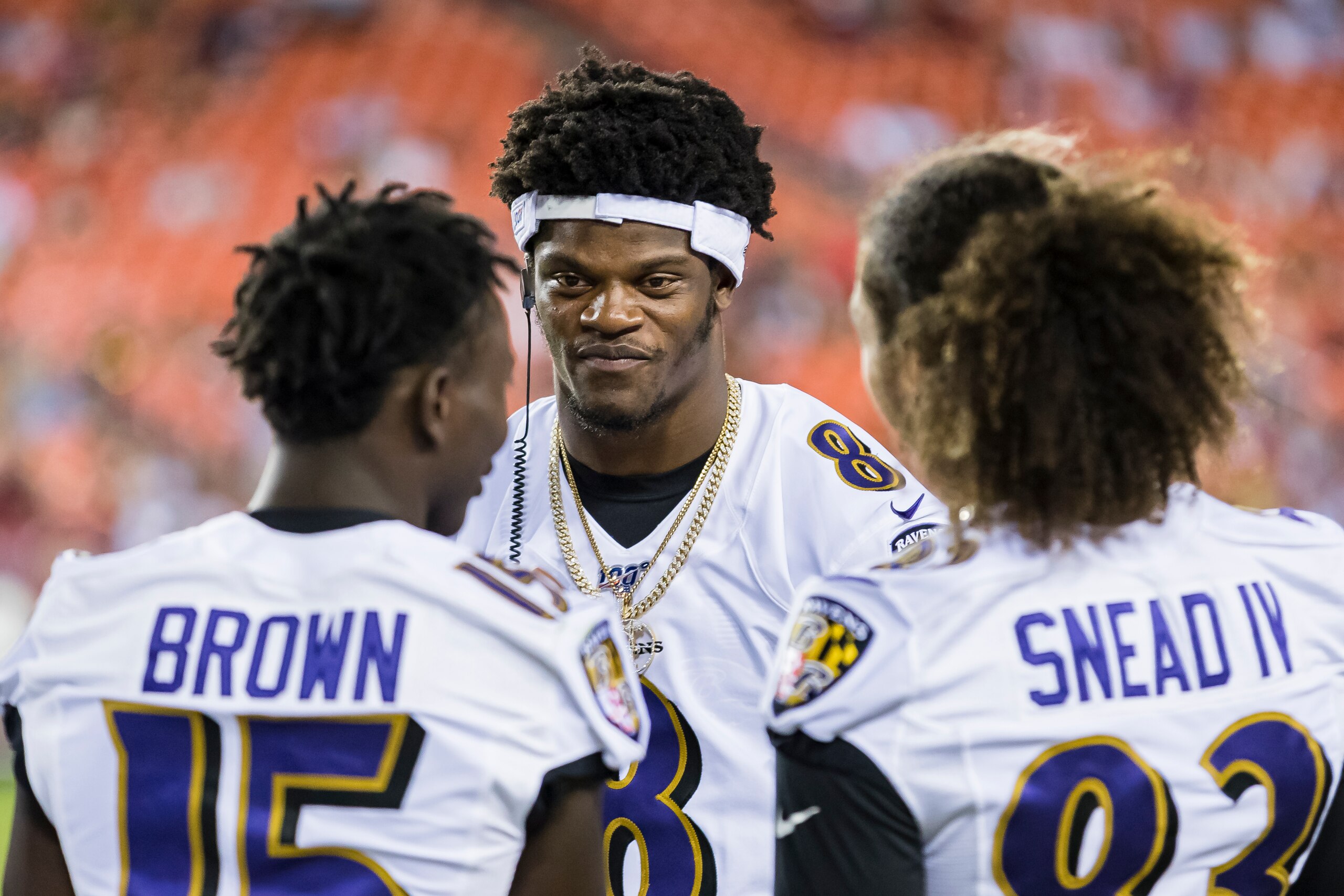LANDOVER, MD - AUGUST 29: Lamar Jackson #8 of the Baltimore Ravens laughs with teammates during the second half of a preseason game against the Washington Redskins at FedExField on August 29, 2019 in Landover, Maryland. (Photo by Scott Taetsch/Getty Image
