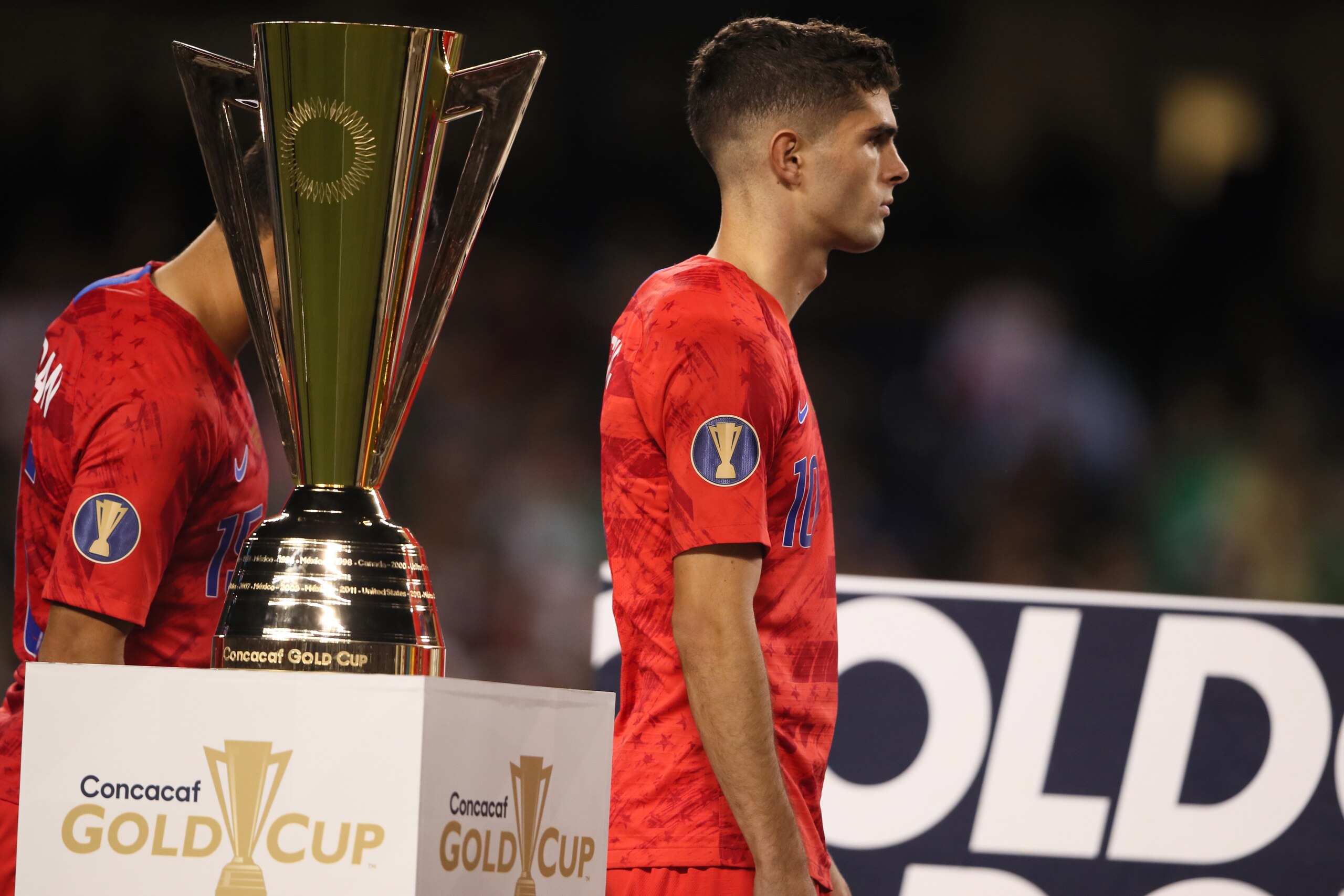 CHICAGO, IL - JULY 07: Christian Pulisic of USA walks past the CONCACAF Gold Cup trophy after USA's 0-1 defeat to Mexico in the 2019 CONCACAF Gold Cup Final between Mexico and United States of America at Soldier Field on July 7, 2019 in Chicago, Illinois.