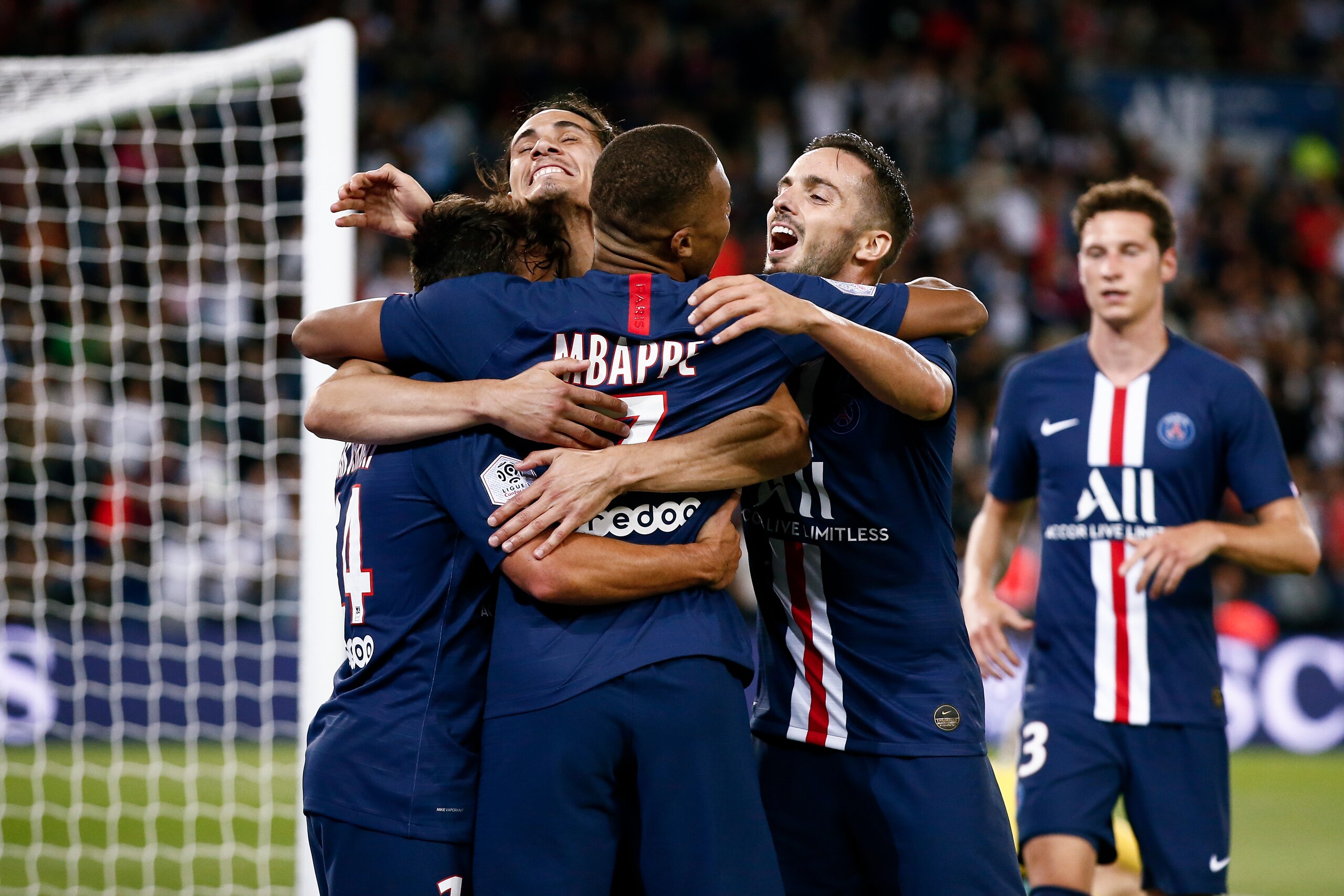PARIS, FRANCE - AUGUST 11: Kylian Mbappe #7 of Paris Saint-Germain celebrates his goal with Juan Bernat Velasco #14, Edinson Cavani #9 and Pablo Sarabia #19 of Paris Saint-Germain during the Ligue 1 match between Paris Saint-Germain and Nimes Olympique at