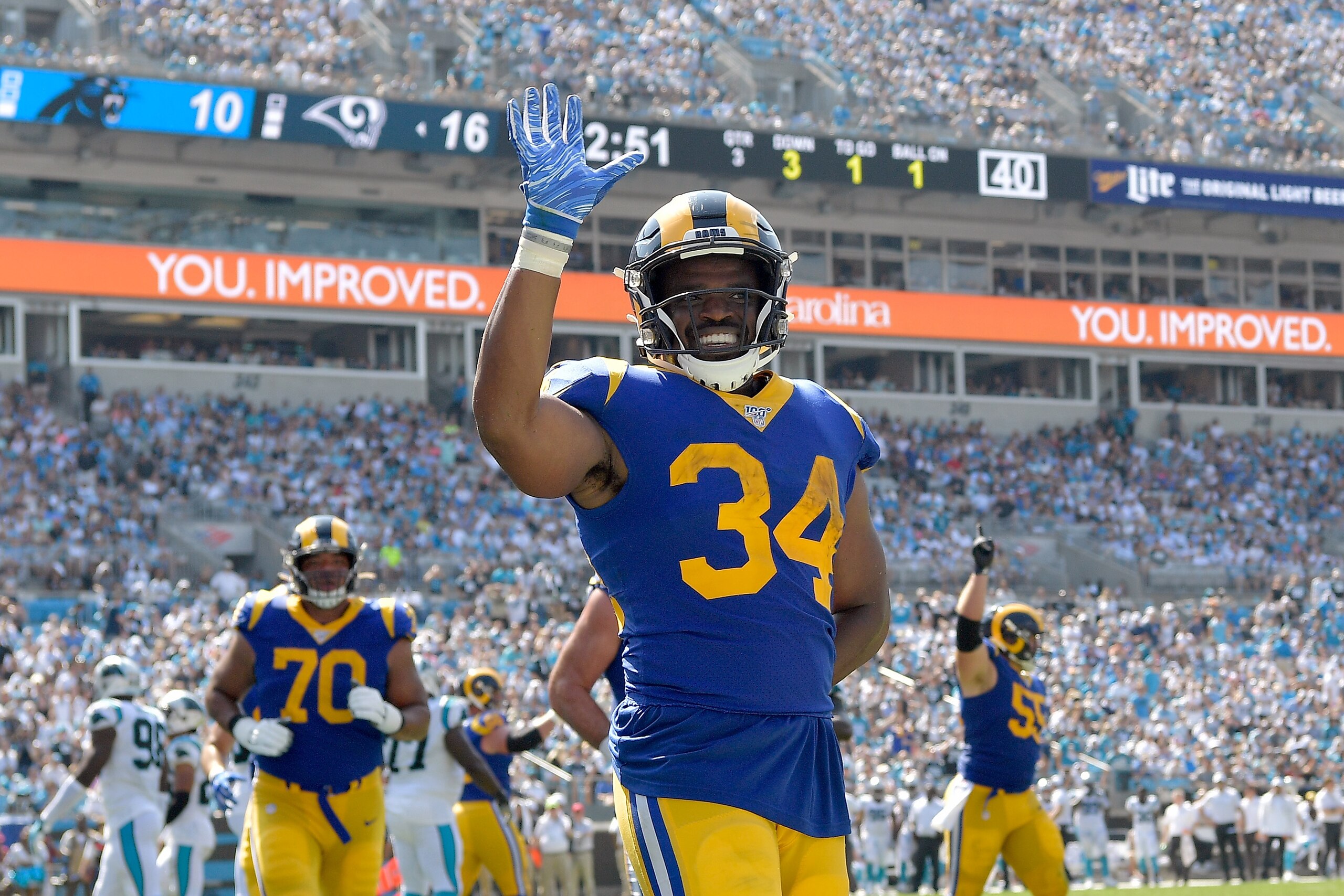 CHARLOTTE, NORTH CAROLINA - SEPTEMBER 08: Malcolm Brown #34 of the Los Angeles Rams waves to the fans after scoring a touchdown against the Carolina Panthers during the third quarter of their game at Bank of America Stadium on September 08, 2019 in Charlo