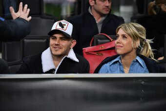 MILAN, ITALY - FEBRUARY 21: Mauro Icardi (L) and Wanda Nara look on in VIP standing during the UEFA Europa League Round of 32 Second Leg match between FC Internazionale and SK Rapid Wien at San Siro on February 21, 2019 in Milan, Italy. (Photo by Tullio P