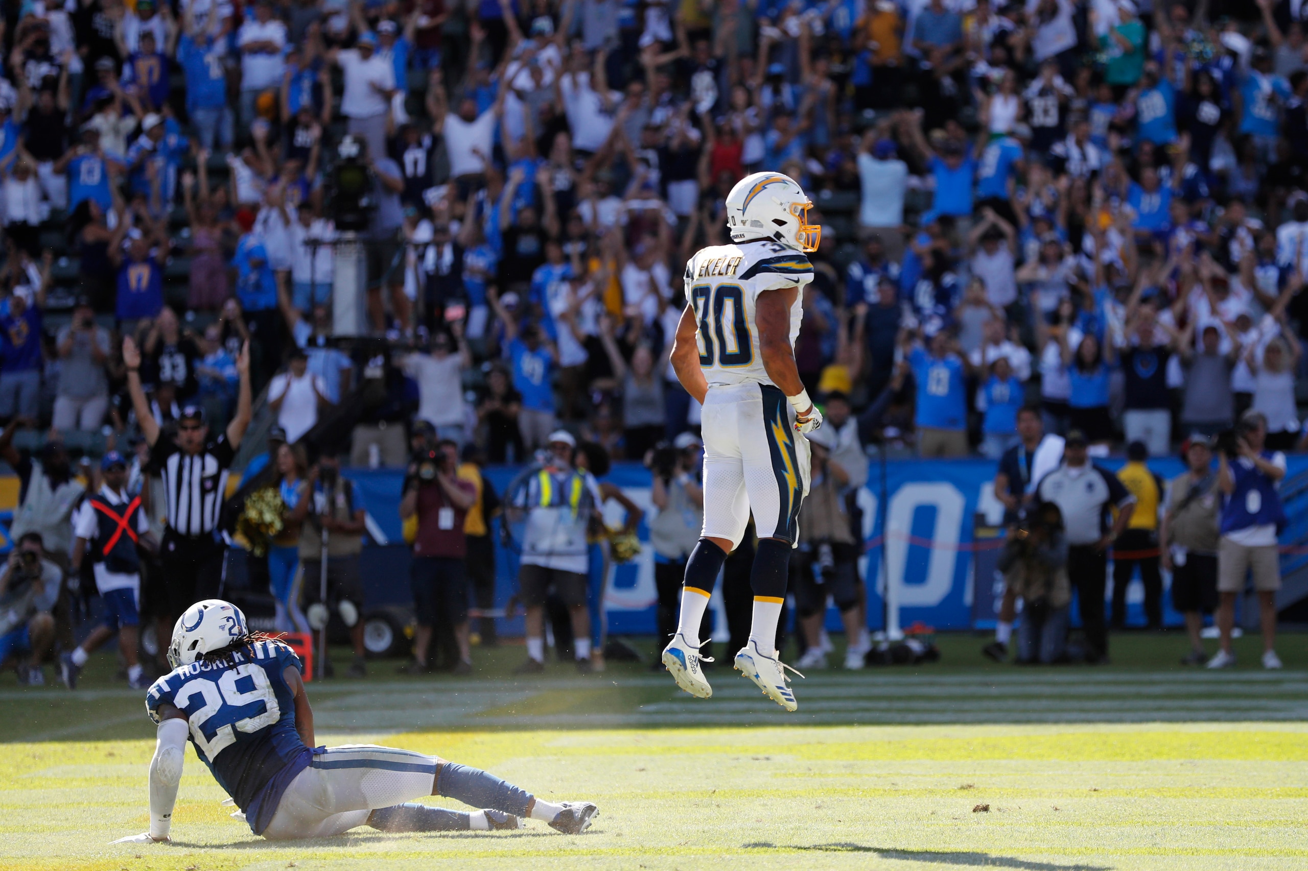 CARSON, CALIFORNIA - SEPTEMBER 08:  Austin Ekeler #30 of the Los Angeles Chargers reacts after scoring a touchdown in overtime as Malik Hooker #29 of the Indianapolis Colts looks on in a game at Dignity Health Sports Park on September 08, 2019 in Carson, 