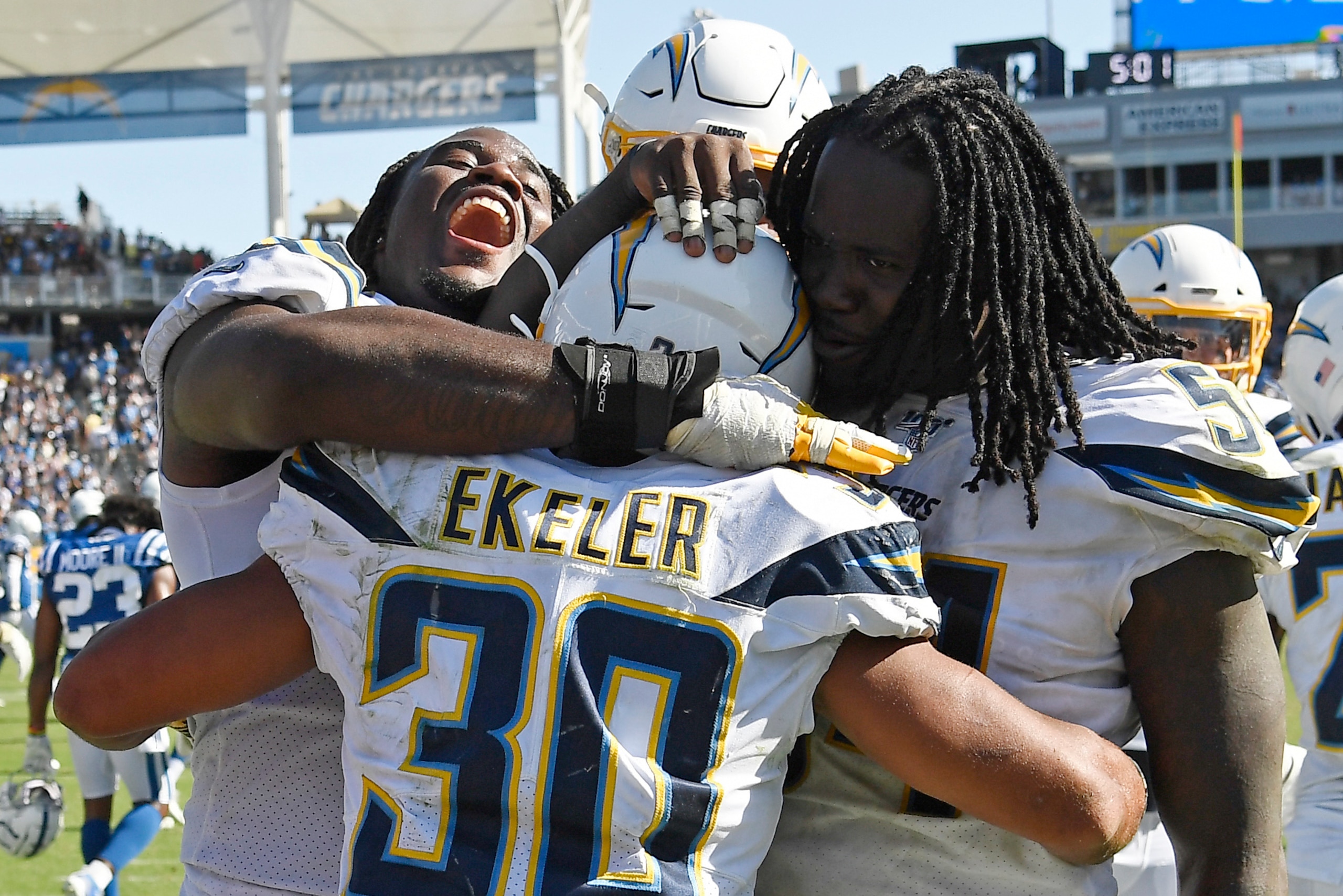 CARSON, CA - SEPTEMBER 08: Running back Austin Ekeler #30 of the Los Angeles Chargers is congratulated by Justin Jones #93 and Melvin Ingram #54 after scoring the winning touchdown in overtime against Indianapolis Colts at Dignity Health Sports Park on Se