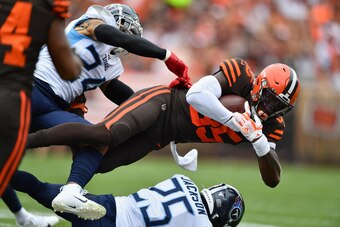 CLEVELAND, OH - SEPTEMBER 08:  David Njoku #85 of the Cleveland Browns is brought down after a catch in the first quarter by Kenny Vaccaro #24 of the Tennessee Titans and Adoree' Jackson #25 of the Tennessee Titans at FirstEnergy Stadium on September 08, 