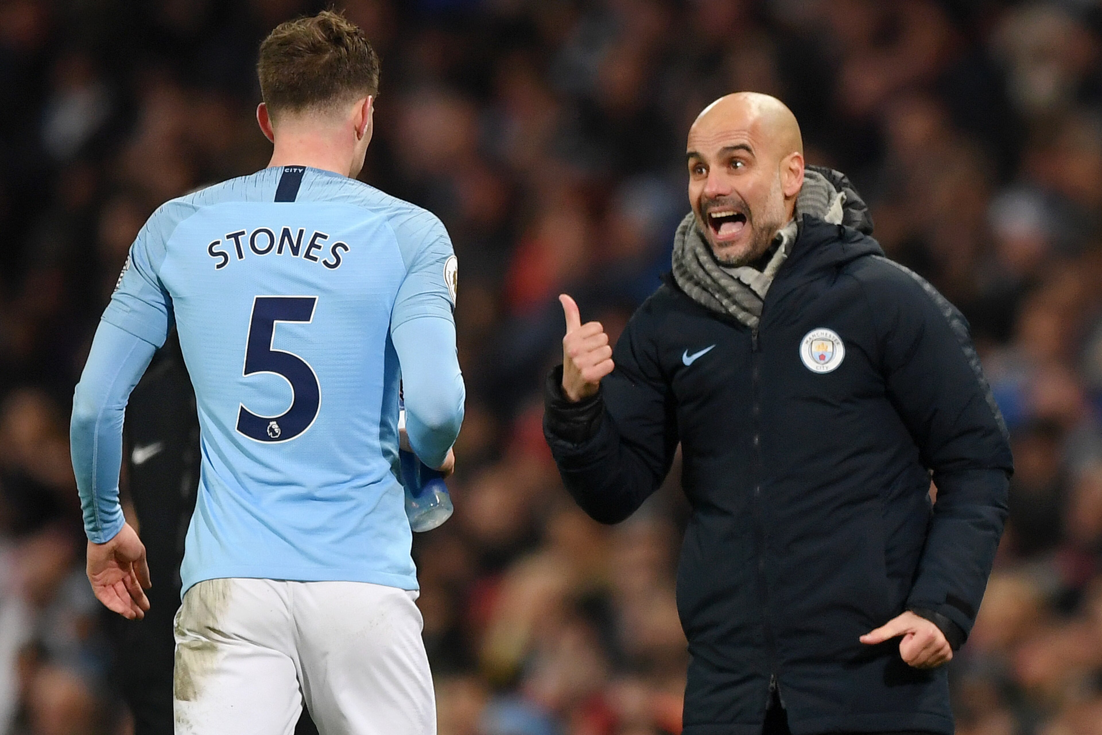 MANCHESTER, ENGLAND - JANUARY 03: Josep Guardiola, Manager of Manchester City speaks to John Stones of Manchester City during the Premier League match between Manchester City and Liverpool FC at the Etihad Stadium on January 3, 2019 in Manchester, United 