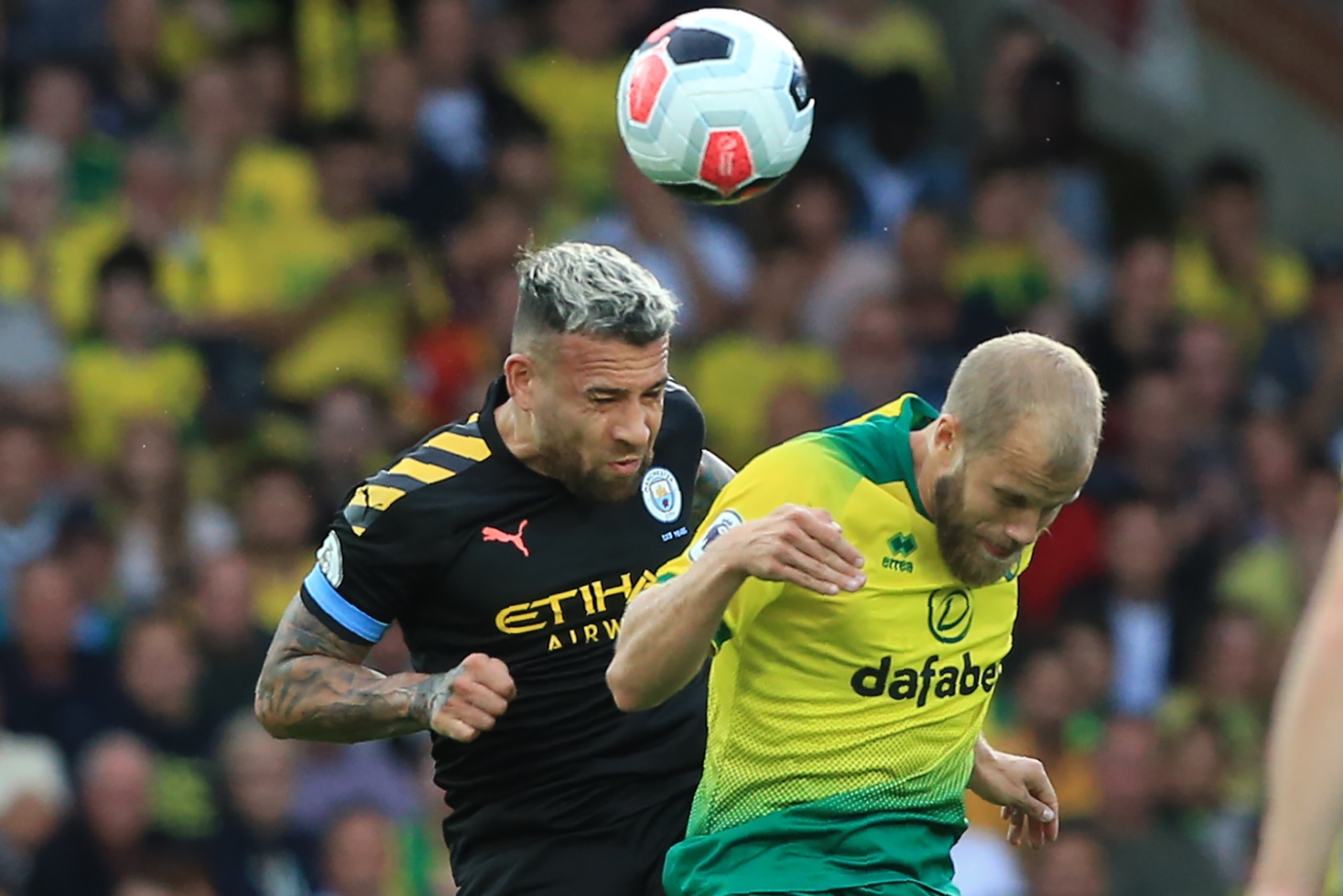 Manchester City's Argentinian defender Nicolas Otamendi (L) vies with Norwich City's Finnish striker Teemu Pukki (R) during the English Premier League football match between Norwich City and Manchester City at Carrow Road in Norwich, eastern England on Se