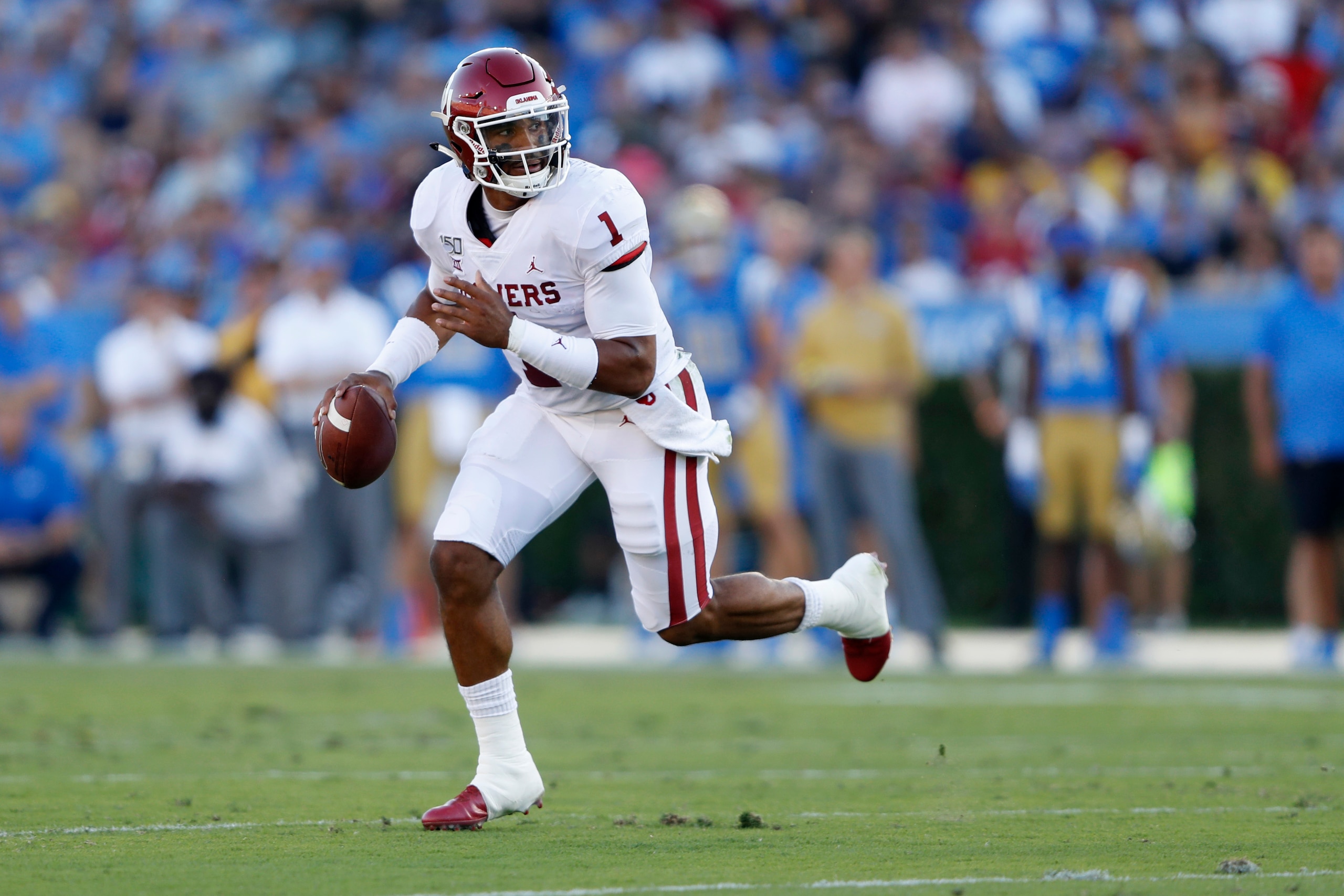 LOS ANGELES, CALIFORNIA - SEPTEMBER 14:  Jalen Hurts #1 of the Oklahoma Sooners breaks free from the pocket on a run during the firt half of a game against the UCLA Bruins at the Rose Bowl on September 14, 2019 in Los Angeles, California. (Photo by Sean M
