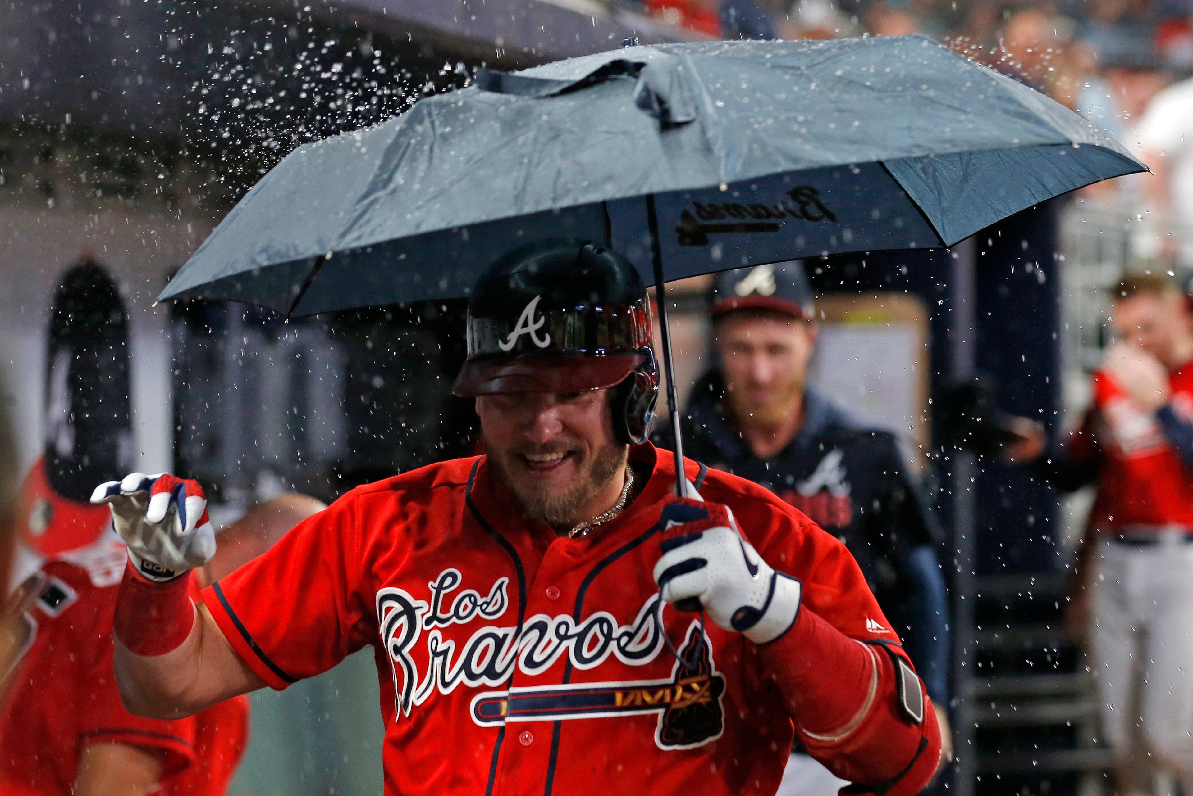 ATLANTA, GEORGIA - SEPTEMBER 06: Third baseman Josh Donaldson #20 of the Atlanta Braves celebrates in the dugout with an umbrella after hitting a 2-run home run in the seventh inning during the game against the Washington Nationals at SunTrust Park on Sep