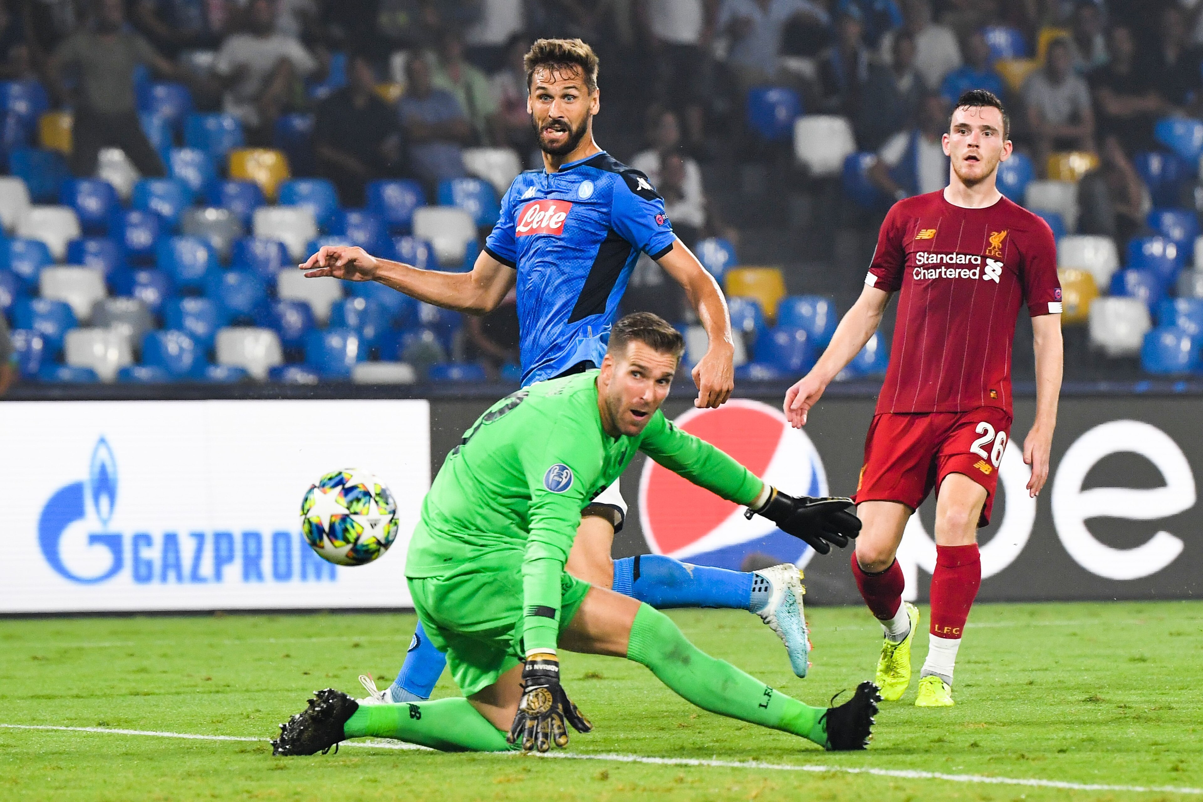 Napoli's Spanish forward Fernando Llorente (C) scores past Liverpool's Spanish goalkeeper Adrian during the UEFA Champions League Group E football match Napoli vs Liverpool on September 17, 2019 at the San Paolo stadium in Naples. (Photo by Andreas SOLARO