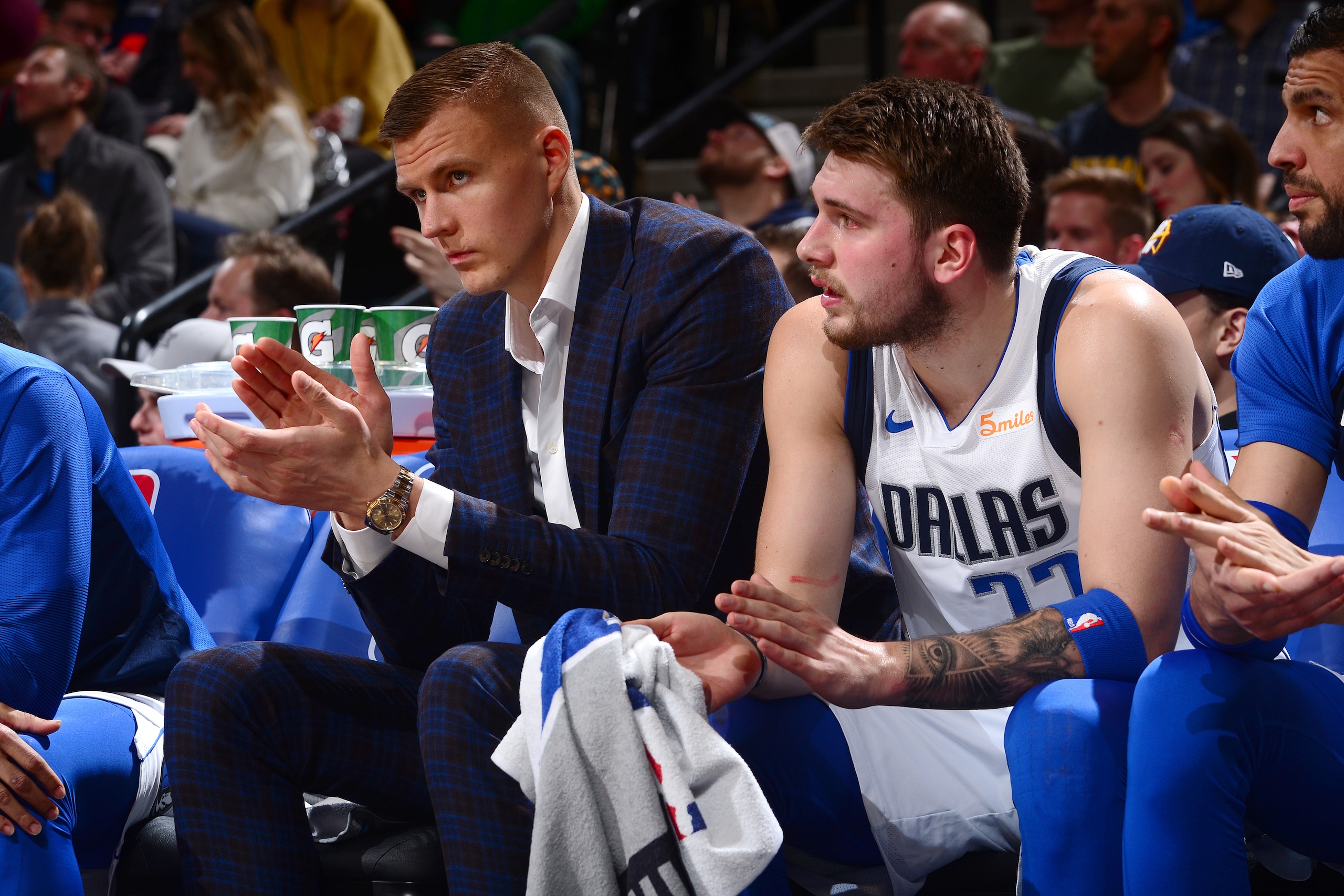 DENVER, CO - MARCH 14: Kristaps Porzingis #6 and Luka Doncic #77 of the Dallas Mavericks react to a play during the game against the Denver Nuggets on March 14, 2019 at the Pepsi Center in Denver, Colorado. NOTE TO USER: User expressly acknowledges and ag