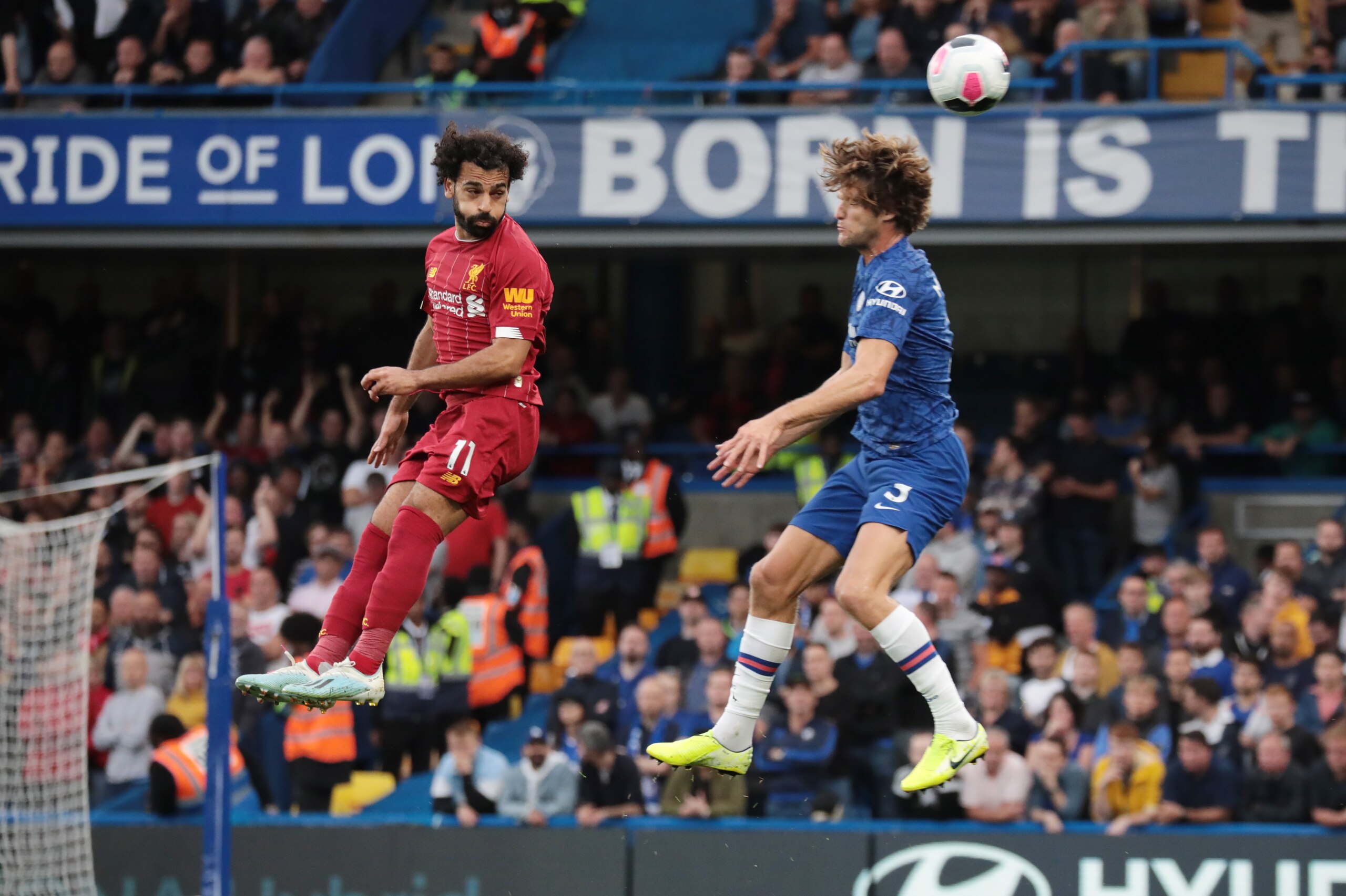 LONDON, ENGLAND - SEPTEMBER 22: Liverpools Mohammed Salah and Marcos Alonso head for the ball during  the Premier League match between Chelsea FC and Liverpool FC at Stamford Bridge on September 22, 2019 in London, United Kingdom. (Photo by Hugo Philpott/