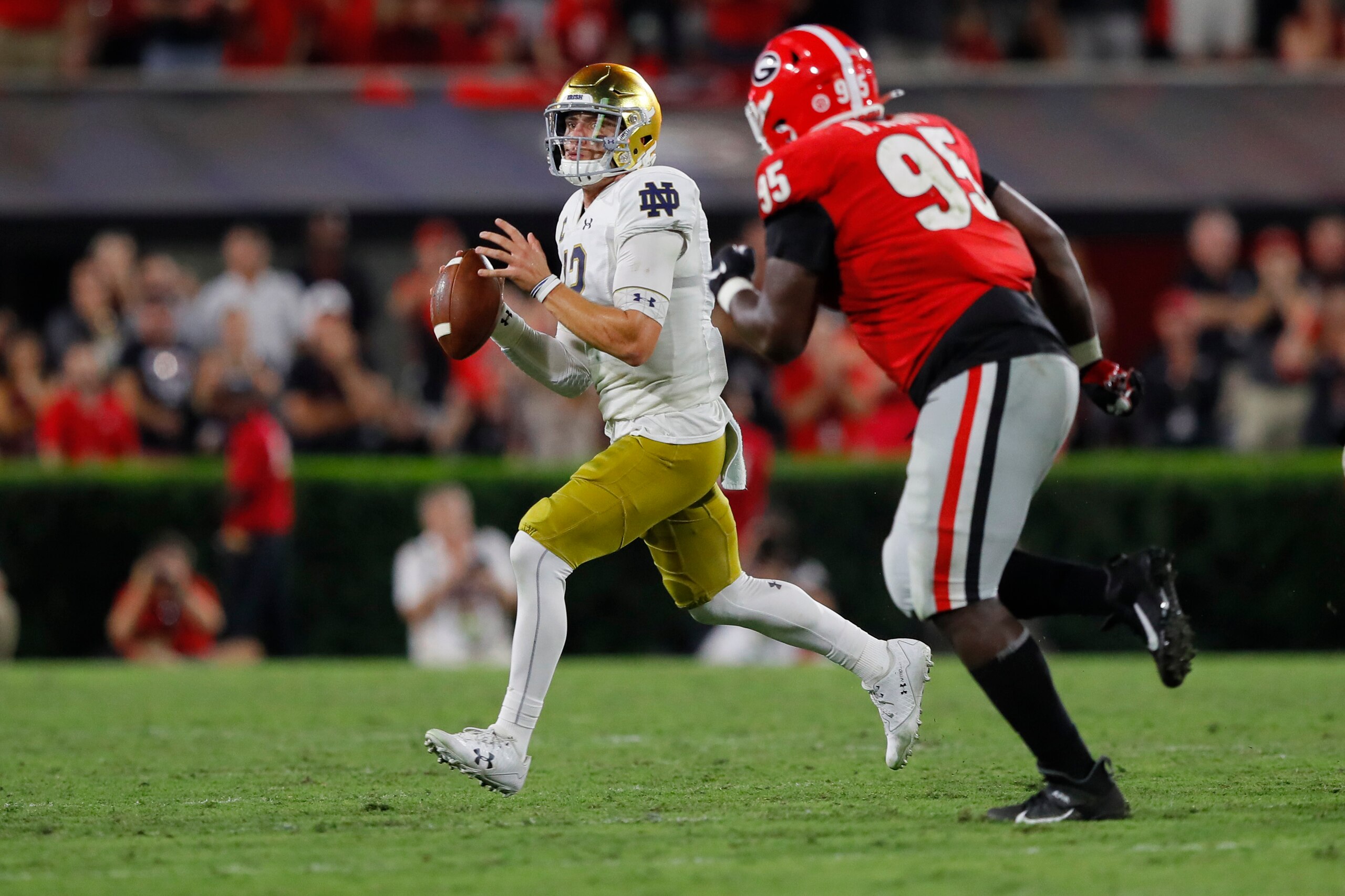 ATHENS, GEORGIA - SEPTEMBER 21: Ian Book #12 of the Notre Dame Fighting Irish looks to throw a second half pass next to Devonte Wyatt #95 of the Georgia Bulldogs at Sanford Stadium on September 21, 2019 in Athens, Georgia. (Photo by Kevin C. Cox/Getty Ima