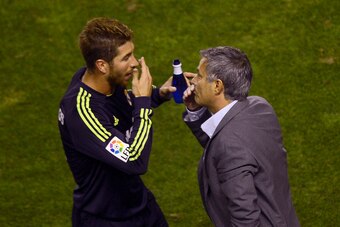 Real Madrid's defender Sergio Ramos (L) speaks with Real Madrid's Portuguese coach Jose Mourinho during the Spanish league football match Rayo Vallecano vs Real Madrid on September 24, 2012 at the Teresa Rivero stadium in Madrid.   AFP PHOTO / PIERRE-PHIL