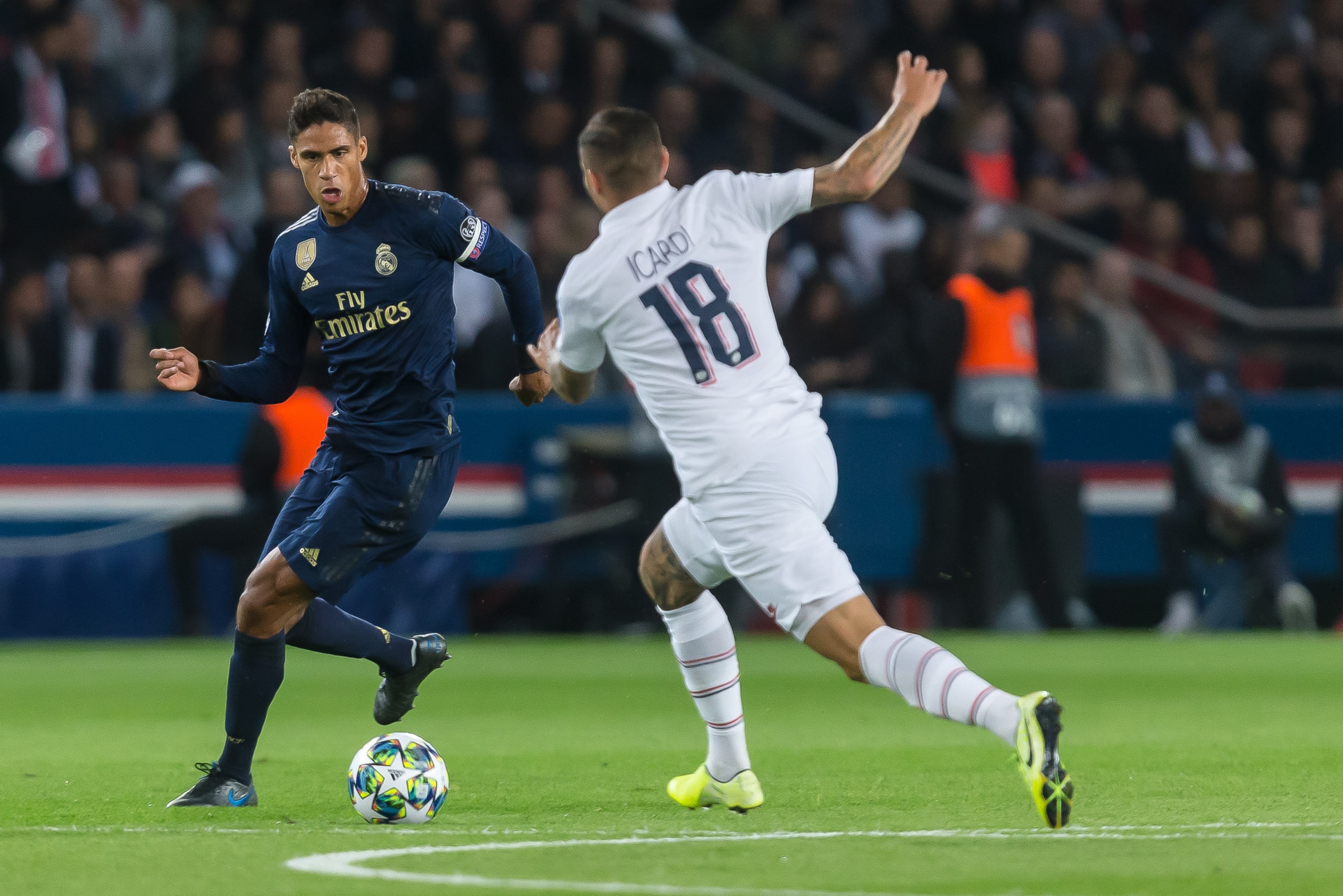 PARIS, FRANCE - SEPTEMBER 18: Raphael Varane of Real Madrid and Mauro Icardi PSG) battle for the ball during the UEFA Champions League group A match between Paris Saint-Germain and Real Madrid at Parc des Princes on September 18, 2019 in Paris, France. (P