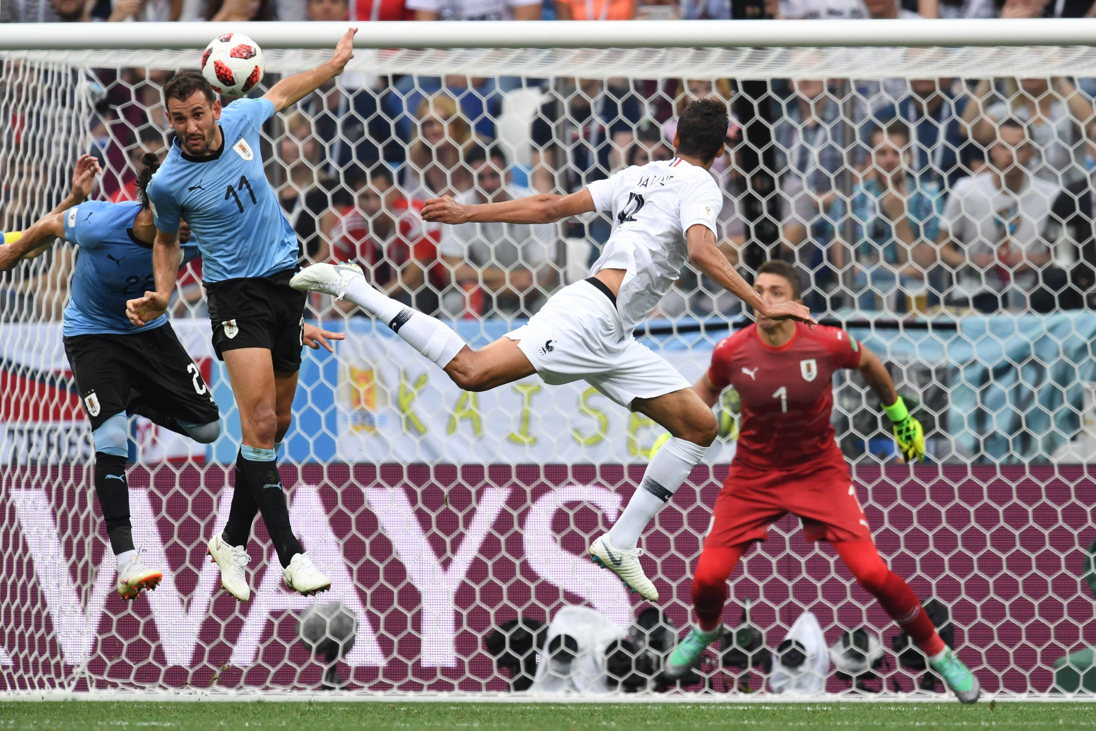 TOPSHOT - France's defender Raphael Varane (2ndR) heads to score the opener past Uruguay's forward Cristhian Stuani during the Russia 2018 World Cup quarter-final football match between Uruguay and France at the Nizhny Novgorod Stadium in Nizhny Novgorod 