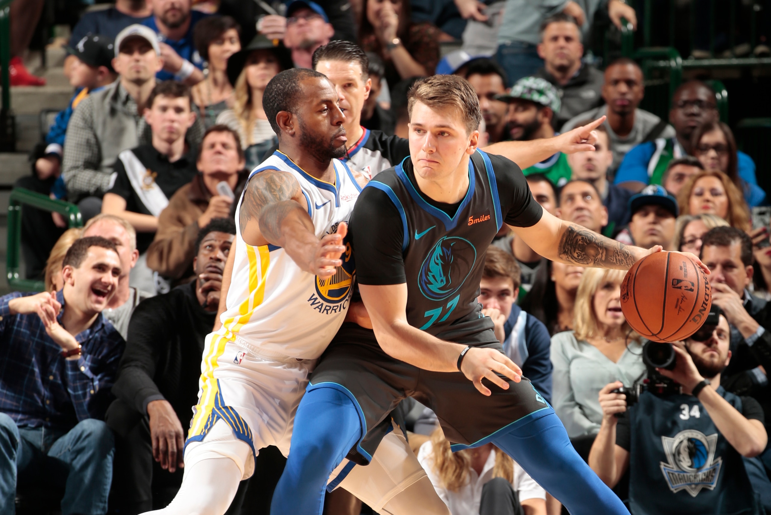 DALLAS, TX - NOVEMBER 17:Andre Iguodala #9 of the Golden State Warriors defends Luka Doncic #77 of the Dallas Mavericks  on November 17, 2018 at the American Airlines Center in Dallas, Texas. NOTE TO USER: User expressly acknowledges and agrees that, by d