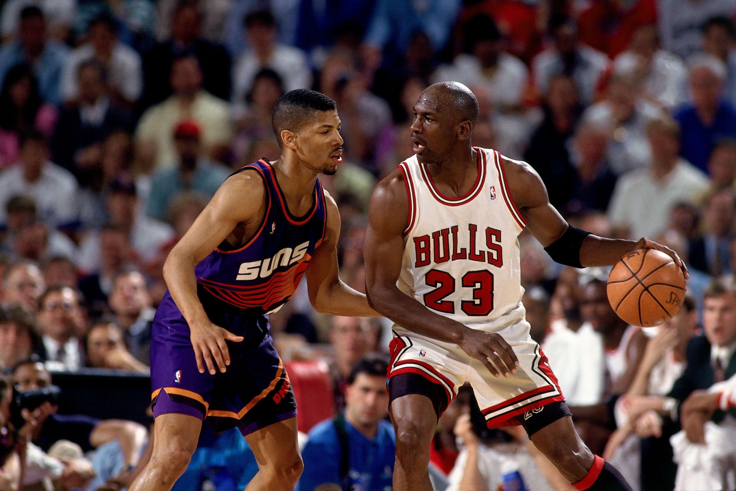 CHICAGO - JUNE 16:  Michael Jordan #23 of the Chicago Bulls posts up against Kevin Johnson #7 of the Phoenix Suns in Game Four of the 1993 NBA Finals on June 16, 1993 at the Chicago Stadium in Chicago, Illinois.  The Bulls won 111-105.  NOTE TO USER: User