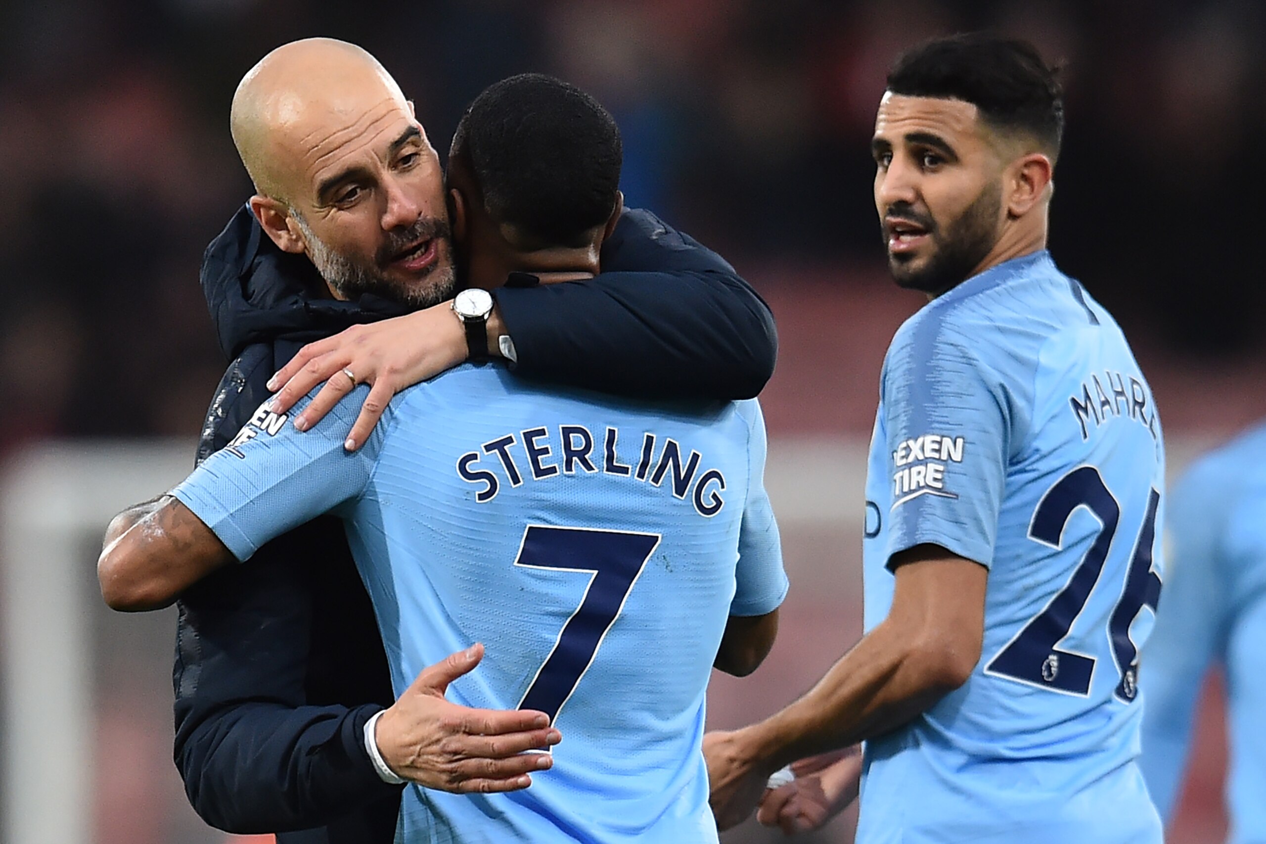 Manchester City's Spanish manager Pep Guardiola (L) hugs Manchester City's English midfielder Raheem Sterling agter the English Premier League football match between Bournemouth and Manchester City at the Vitality Stadium in Bournemouth, southern England 