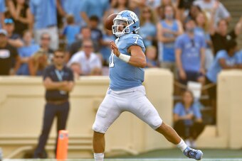 CHAPEL HILL, NORTH CAROLINA - SEPTEMBER 21: Sam Howell #7 of the North Carolina Tar Heels rolls out to pass against the Appalachian State Mountaineers during the second half of their game at Kenan Stadium on September 21, 2019 in Chapel Hill, North Caroli