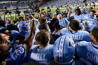 CHAPEL HILL, NORTH CAROLINA - SEPTEMBER 07: Head coach Mack Brown of the North Carolina Tar Heels  celebrates with players after a win against the Miami Hurricanes at Kenan Stadium on September 07, 2019 in Chapel Hill, North Carolina. North Carolina won 2
