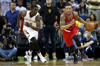 NEW ORLEANS, LA - MARCH 18:  Damian Lillard #0 of the Portland Trail Blazers dribbles the ball past Jrue Holiday #11 of the New Orleans Pelicans during the second half at the Smoothie King Center on March 18, 2016 in New Orleans, Louisiana. NOTE TO USER: 
