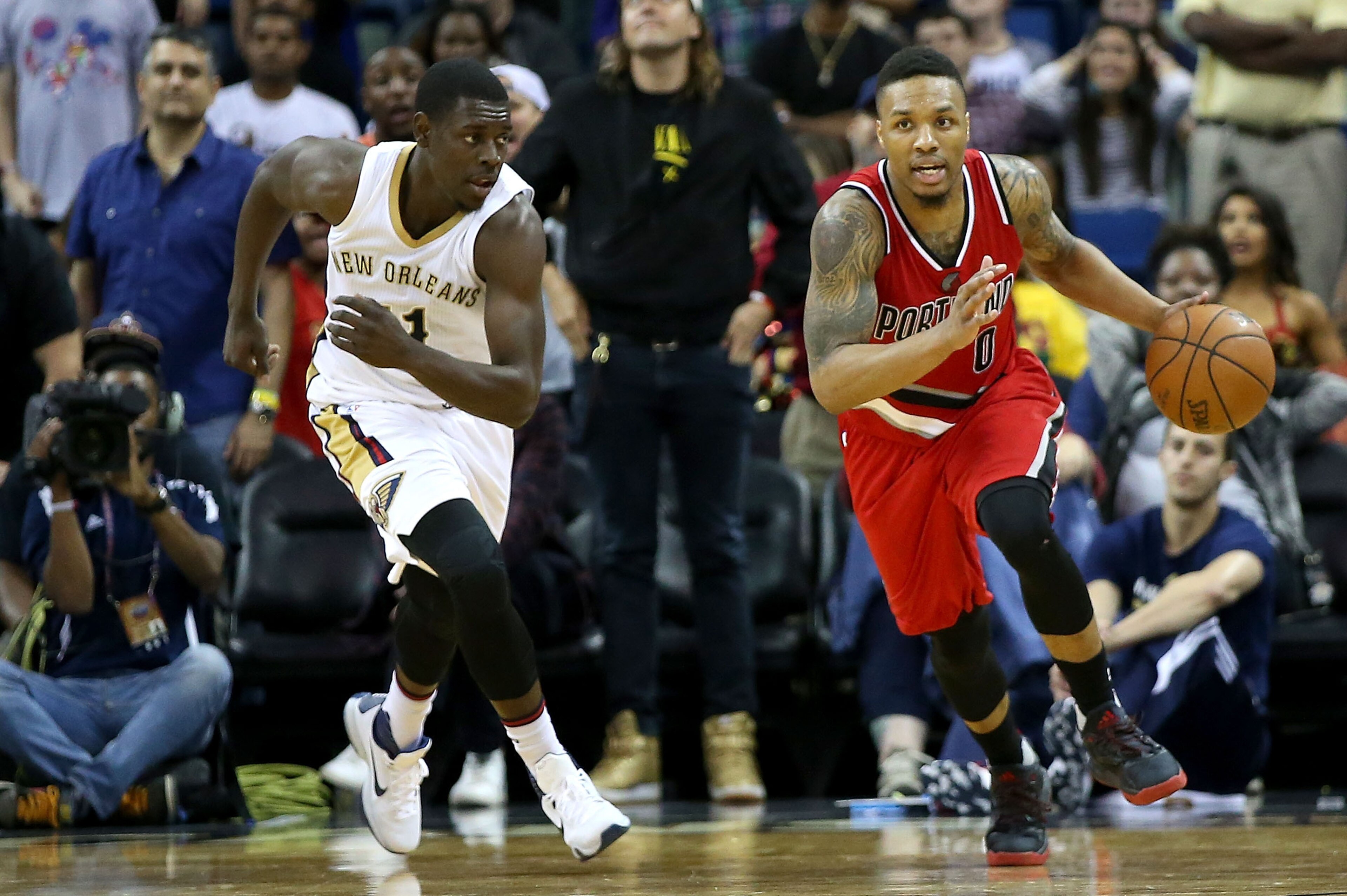 NEW ORLEANS, LA - MARCH 18:  Damian Lillard #0 of the Portland Trail Blazers dribbles the ball past Jrue Holiday #11 of the New Orleans Pelicans during the second half at the Smoothie King Center on March 18, 2016 in New Orleans, Louisiana. NOTE TO USER: 
