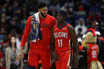 NEW ORLEANS, LOUISIANA - DECEMBER 12:  Anthony Davis #23 of the New Orleans Pelicans and Jrue Holiday #11 of the New Orleans Pelicans talk at a timeout against the Oklahoma City Thunder at Smoothie King Center on December 12, 2018 in New Orleans, Louisian